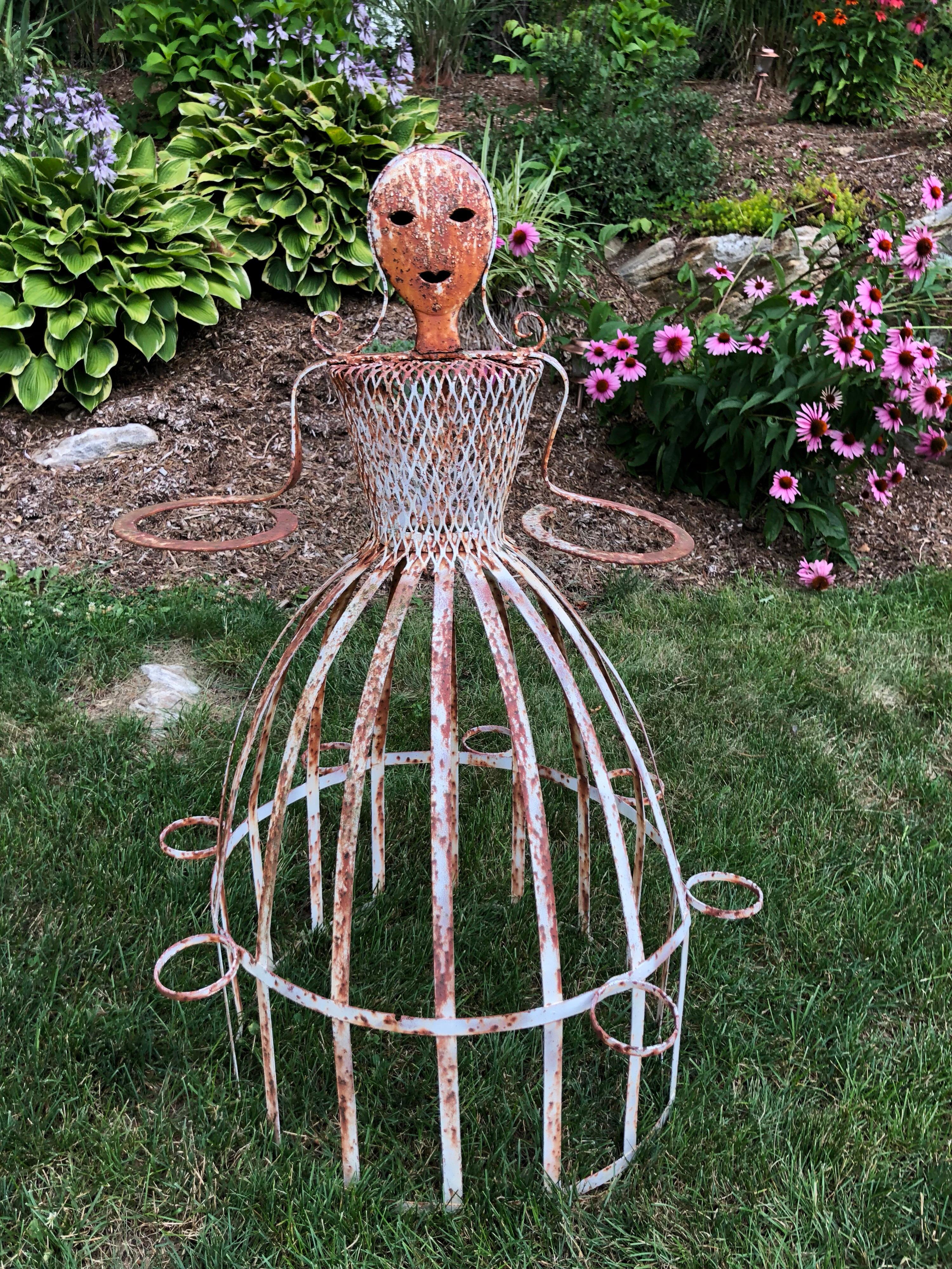 French garden planter in the shape of a Maiden. Attributed to Colette Guerdon. Iron whimsical garden ornament.
Can be repainted if desired or leave rustic and distressed. Has circular pot holders around her hands as well as the rim of her dress to