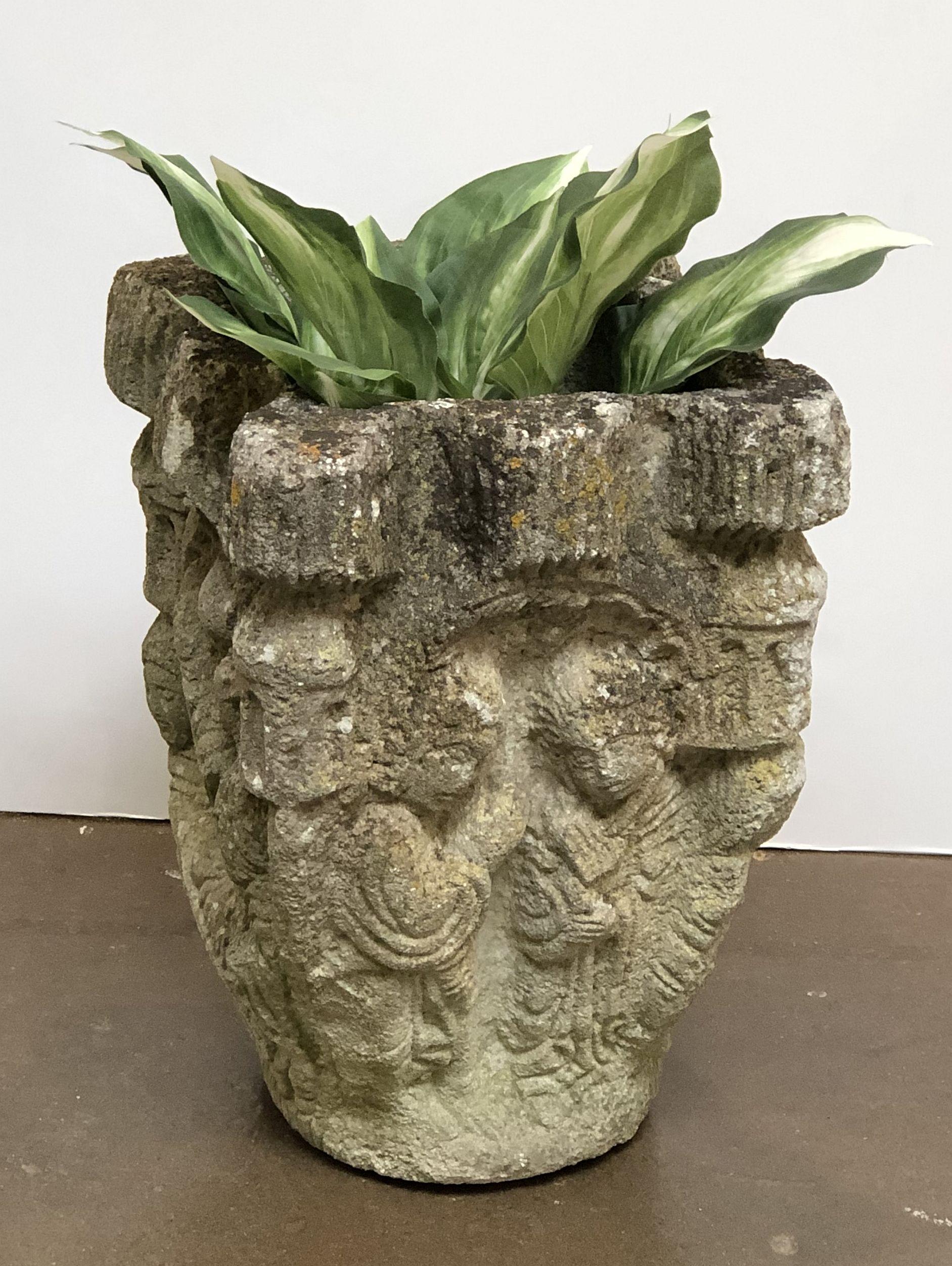 A fine French garden pot or planter urn of composition stone, featuring a weathered exterior relief of figures around the circumference.

A beautiful addition to an indoor or outdoor garden room, garden, or patio.

Dimensions are H 16 1/2 inches