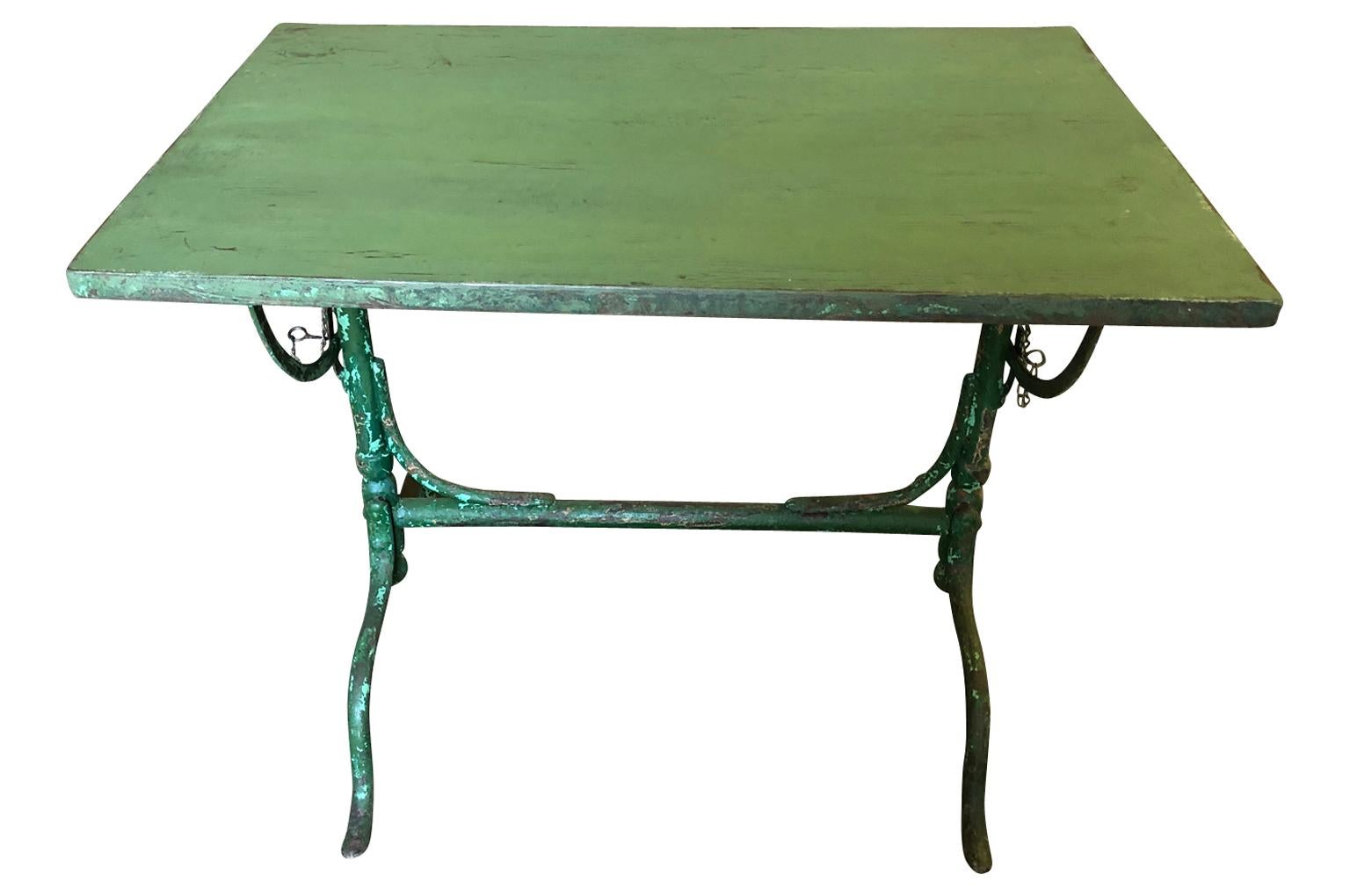 A charming late 19th-early 20th century tilt top garden table in painted iron from the Provence region of France.