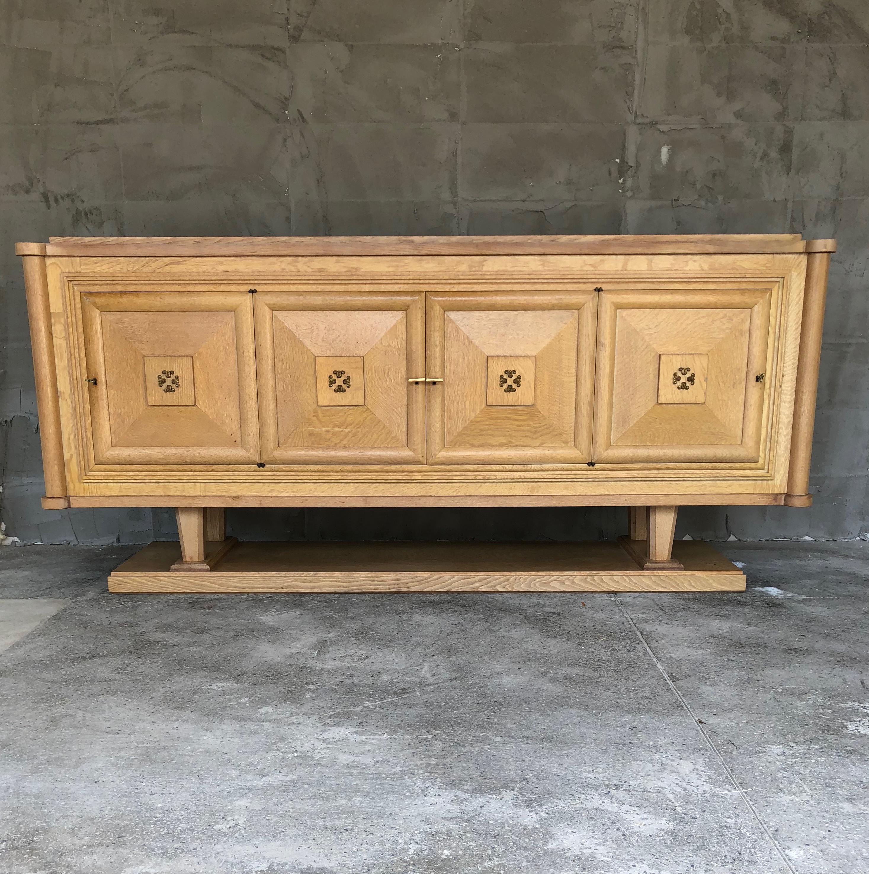 Flawless French Art Deco sideboard by the famous French designer Gaston Poisson made from cerused oak. The sideboard is composed by different basic parts, around box construction in the middle, very easy to be disassembled. Four doors, three
