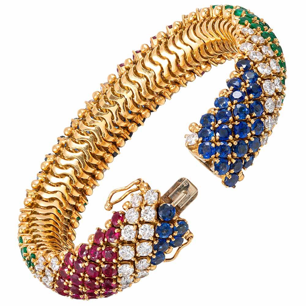Exquisitely appointed with royal blue sapphires (11.20 carats), rich red rubies (8.50 carats), intense green emeralds (6.16 carats) and brilliant white diamonds (8.40 carats), this striking bracelet marries classic design often seen in the creations
