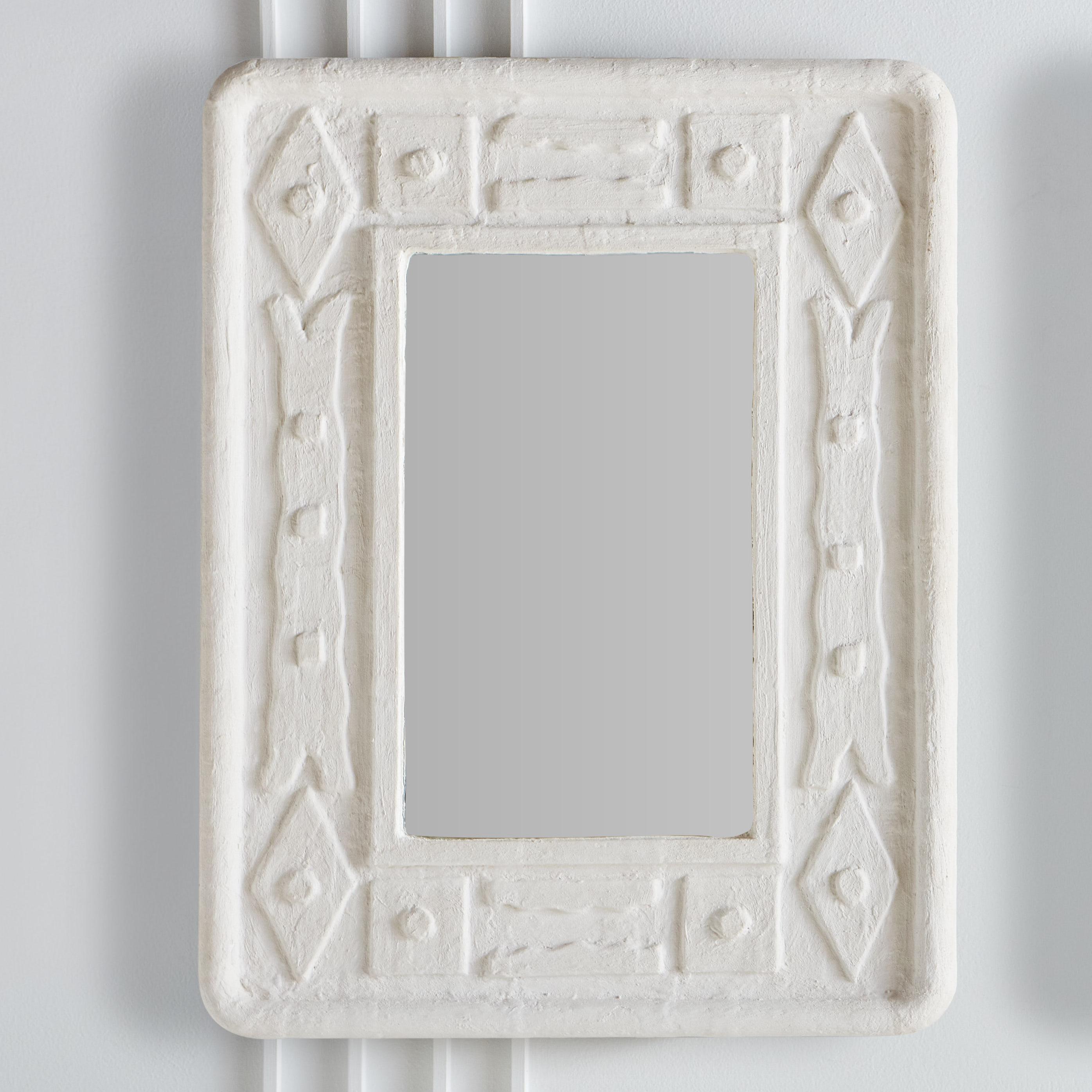A contemporary rectangular white plaster frame mirrors with an incised geometric pattern. This would look beautiful in an entryway or over a mantel. Sourced in France. One Available.
