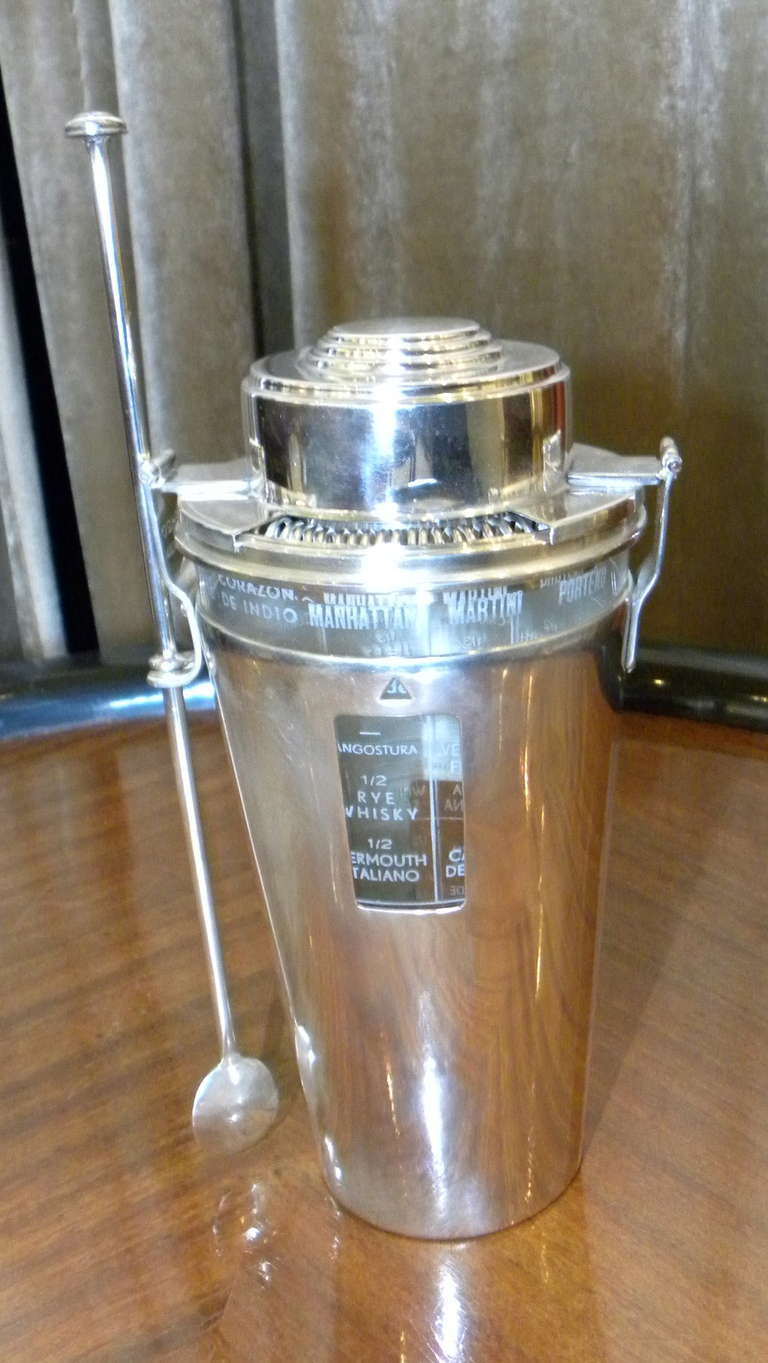 A very interesting, complete, and very rare cocktail shaker. Made in France for the export market in the early 1930s. The information for 24 different recipes is all in Spanish (or mostly). The condition is excellent, newly restored chromed brass