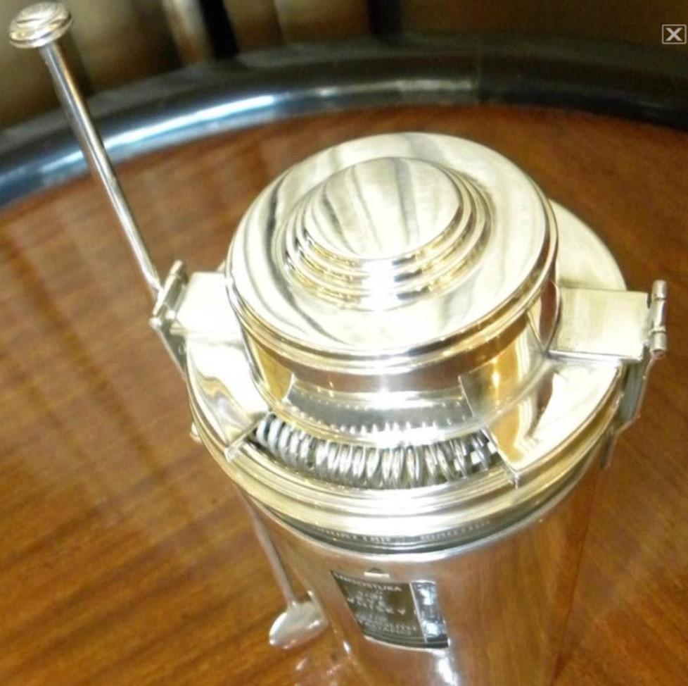 A very interesting, complete, and very rare cocktail shaker. Made in France for the export market in the early 1930s. The information for 24 different recipes is all in Spanish (or mostly). The condition is excellent, newly restored chromed brass