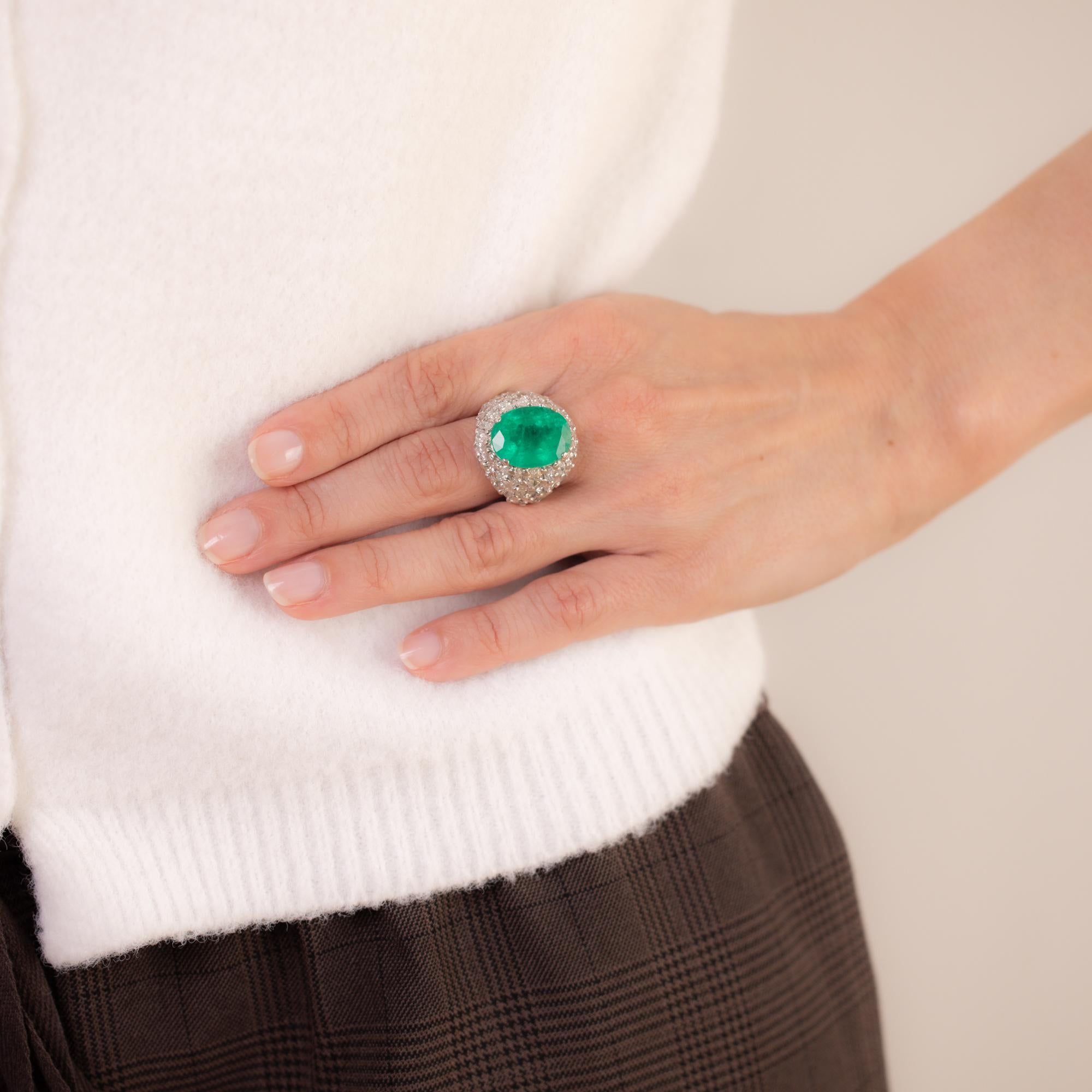 This vintage French 18k white gold ring features a GIA-certified 11.52-carat oval-cut Colombian emerald, F2 treatment, accented by 38 marquise-cut diamonds totaling approximately 5.50 carats, J-K color, I clarity. Hallmarked with the French eagle
