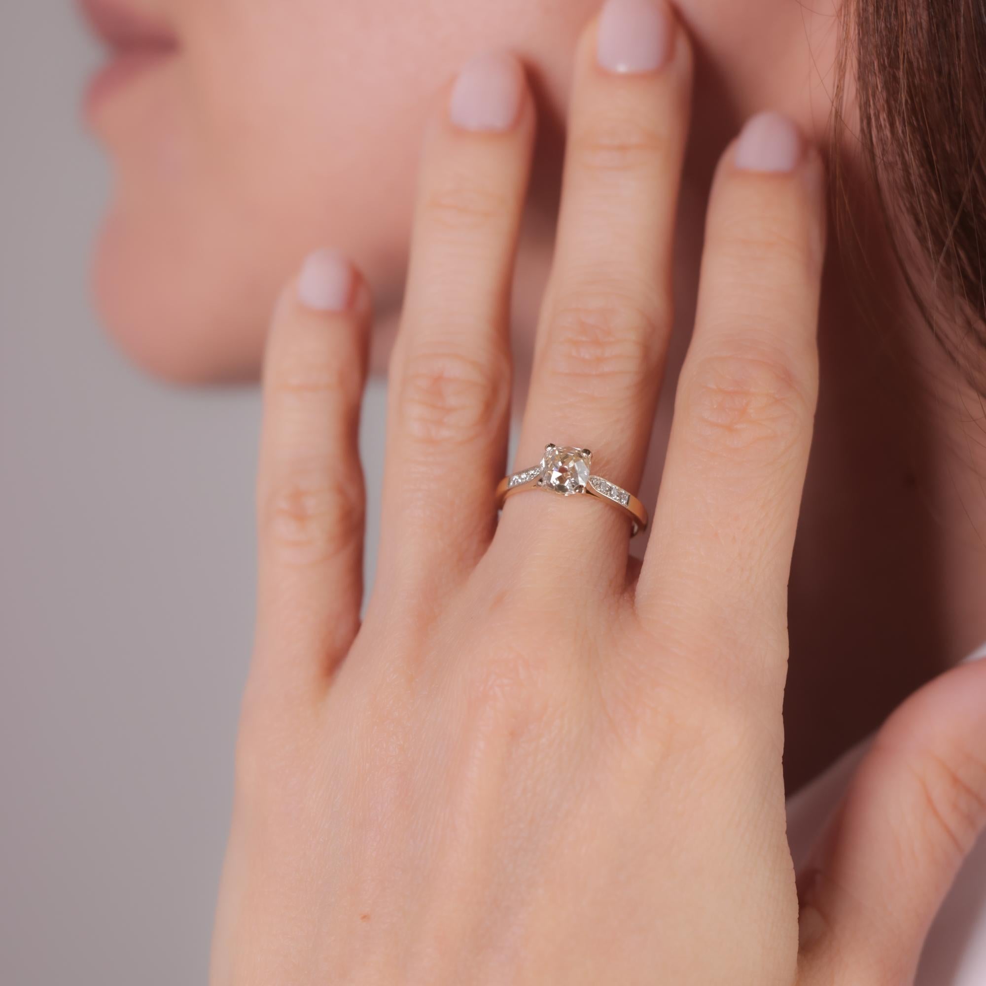This modern ring features a GIA-certified 1.38-carat old mine cut diamond, N color (very light brown), VS2 clarity, accented by eight round brilliant diamonds totaling approximately 0.08 carats, E color, VS clarity, set in 18k yellow gold and