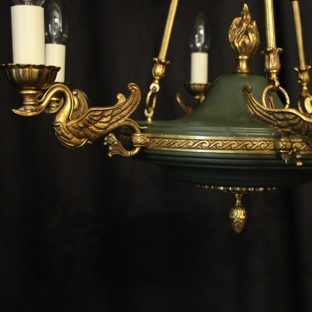 A French Empire gilded cast brass and green enamelled 6-light chandelier, the decorative winged swan scrolling arms, issuing from an ornate etched circular band with acorn base, flame centre finial and green enamelled centre, with the original chain