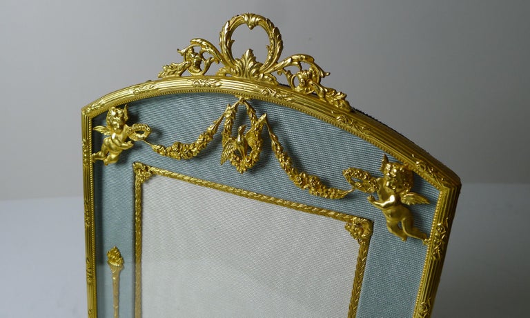 A magnificent French picture frame made from bronze and smothered in gold, beautifully restored to it's former glory and ready to adorn the finest of homes for another 100 years.

The mount on top of the glass features a pair of Cherub or Putti