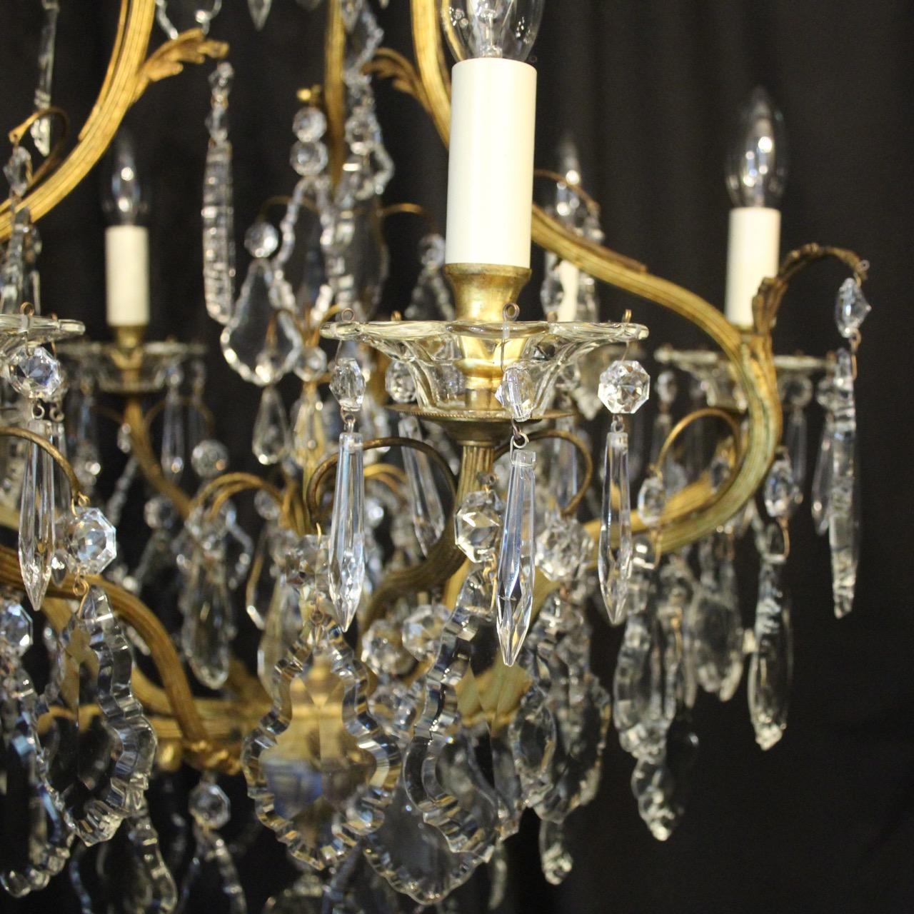A French gilded brass and crystal seven-light birdcage form antique chandelier, the 6 reeded scrolling arms with glass bobeche drip pans and bulbous candle sconces, issuing from an foliated cage form interior with a single inverted light fitting and