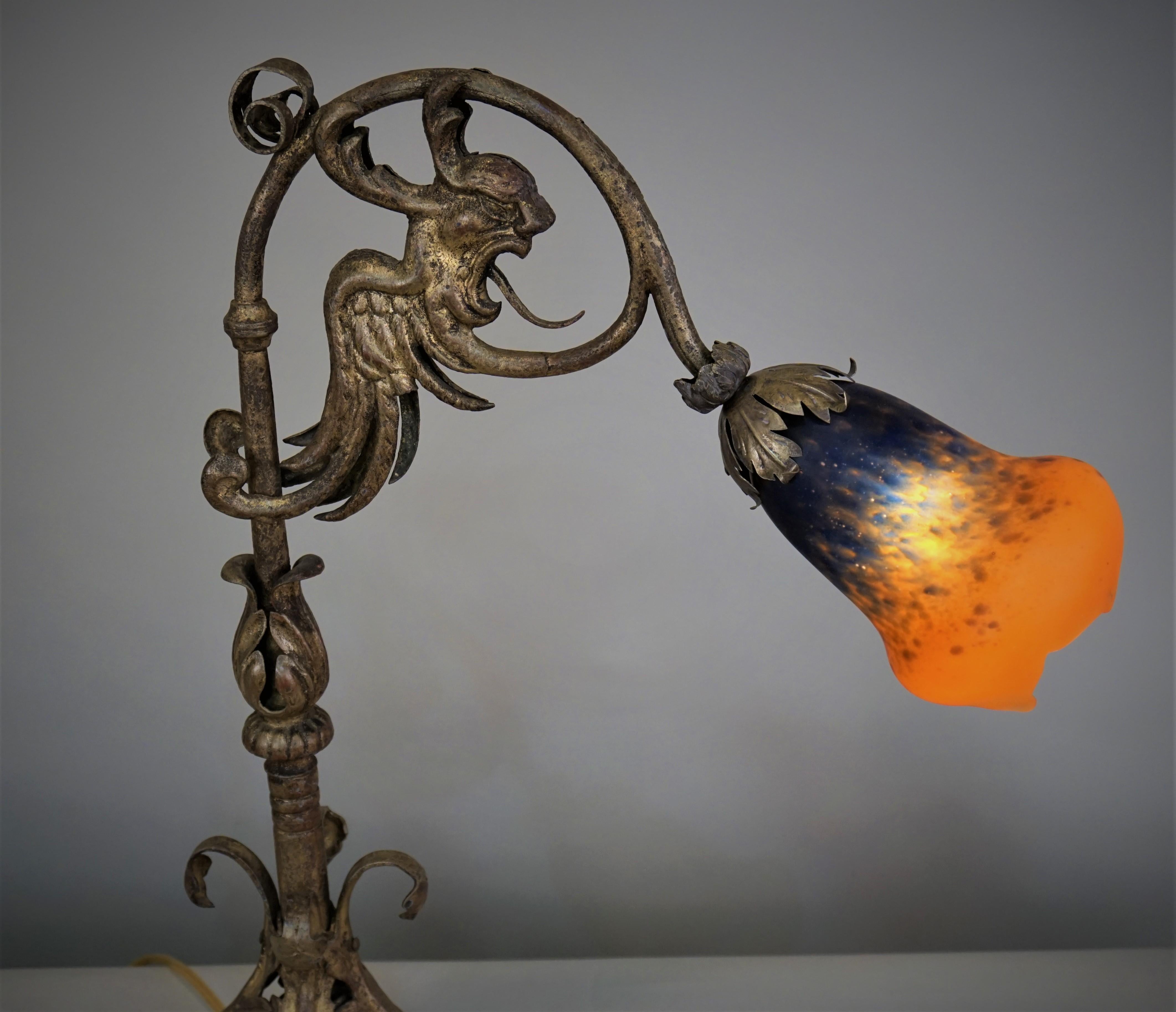 Gilded iron with hand blown glass shade table lamp.