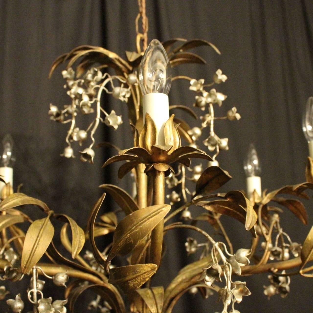 A lovely decorative French gilded leaf and Lilly of the valley six-light chandelier, the leaf scrolling arms with foliated sectional leaf bobeche drip pans, issuing from a leaf central column with decoratively draped with silver gilded lily of the