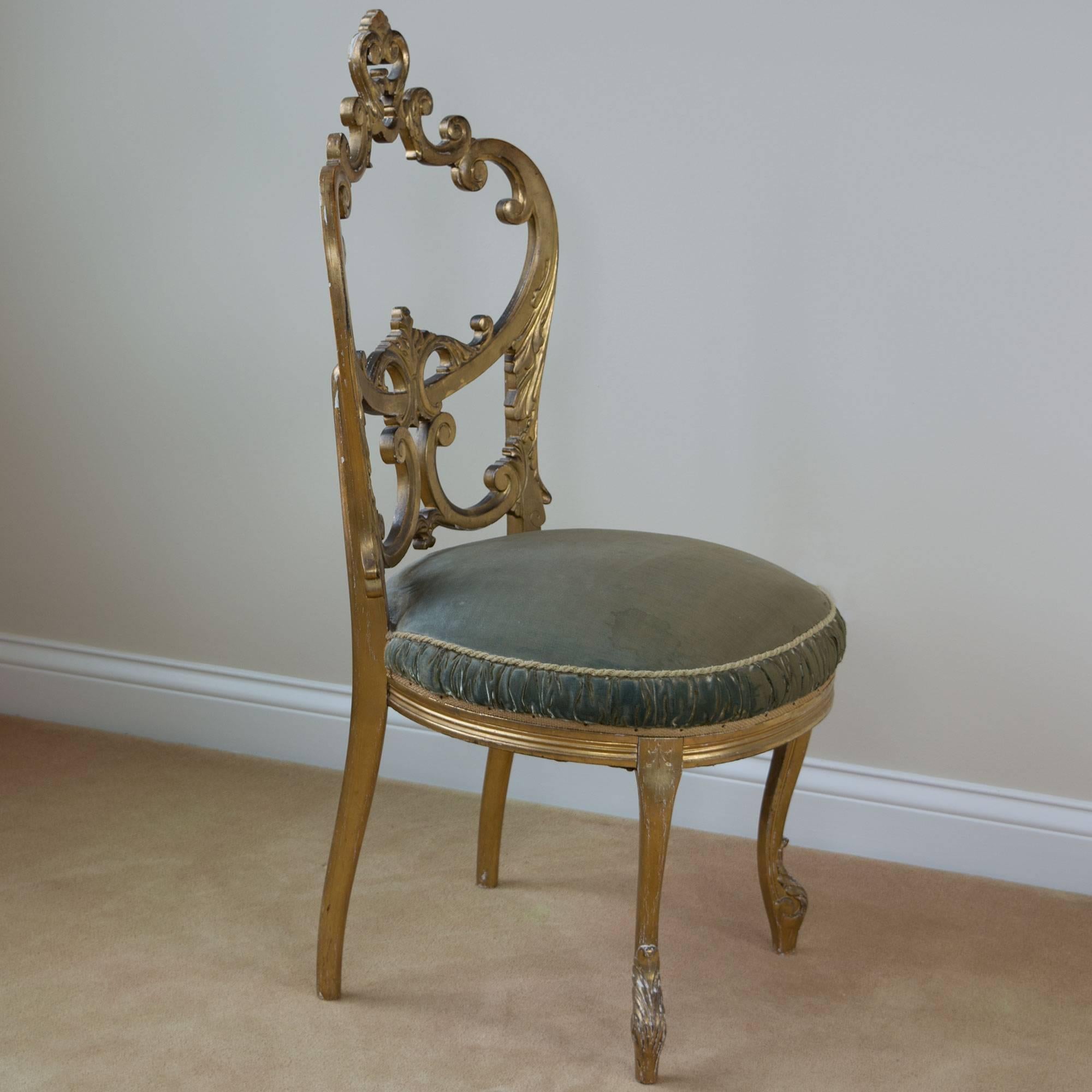 A gorgeous Louis XV style salon chair in giltwood with intricately carved back, slightly curved cabriole legs holds a round seat in tufted velvet. Measure: Seat height 17.5 inches.