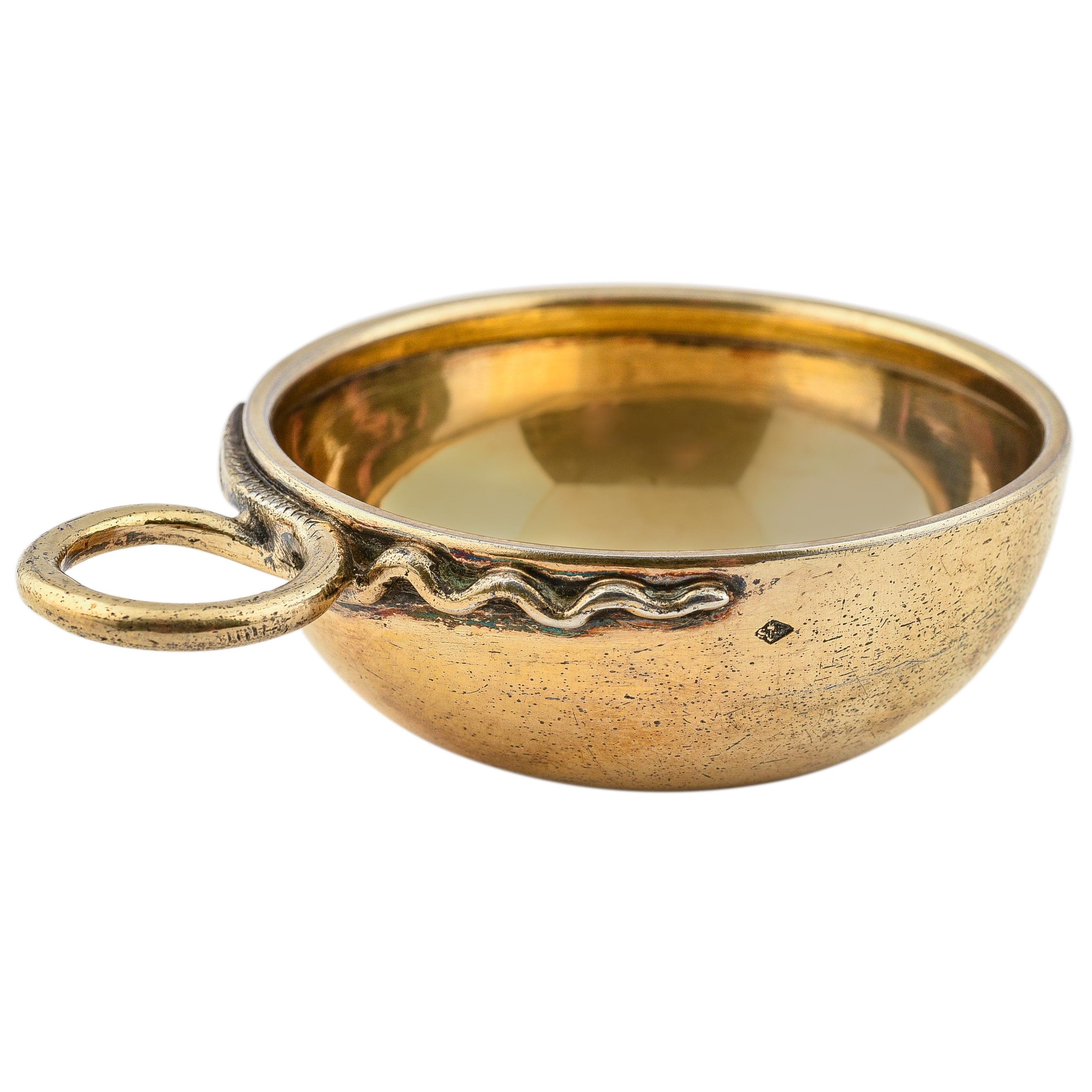 The base of the gilded interior engraved France, Dieu Protège, the handle formed as a stylized serpent.

Minerva stamp and date in Roman numerals

-2 in. (5.1 cm) diam.; ¾ in. (1.9 cm) high

Tasters for cognac, Armagnac or calvados are smaller than