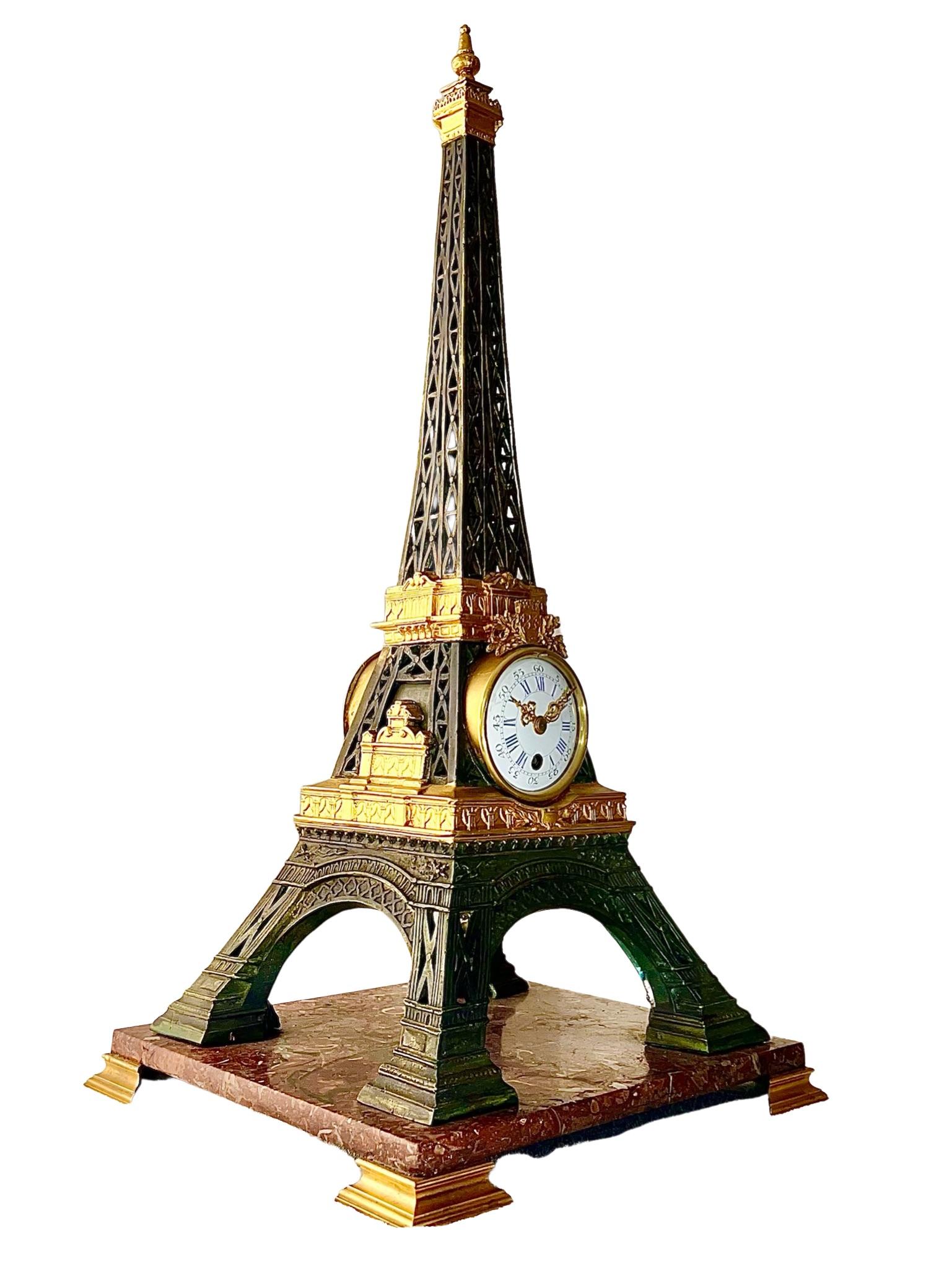 A magnificent French antique clock in the style of The Eiffel Tower. It was produced in the late 19th Century as a souvenir to celebrate the building of this iconic French landmark.

The clock is in a bronze case on a rouge griotte marble base,
