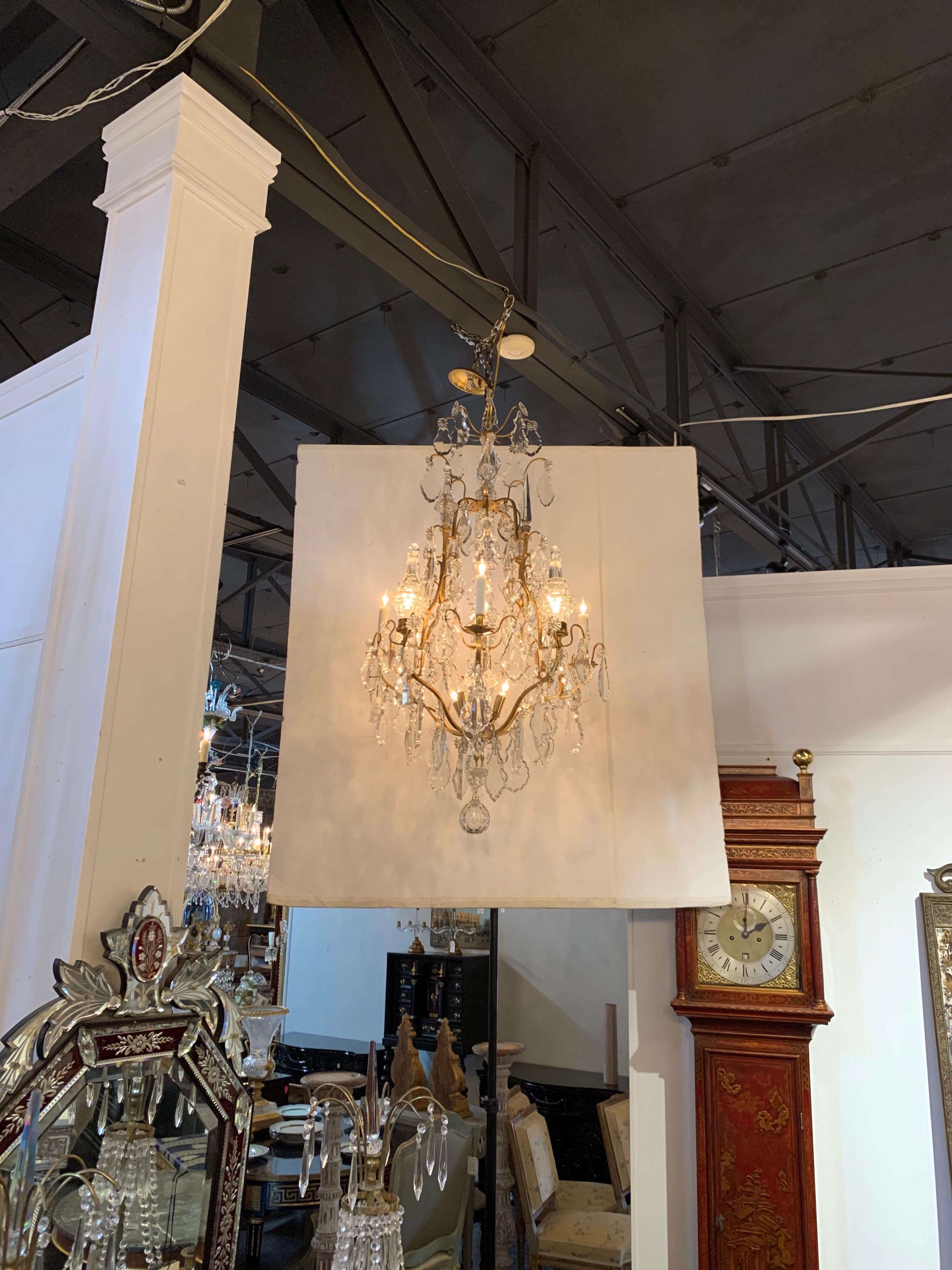Lovely French gilt and bronze crystal chandelier. The fixture has 11 lights and a multitude of large dangling crystals. Very elegant!