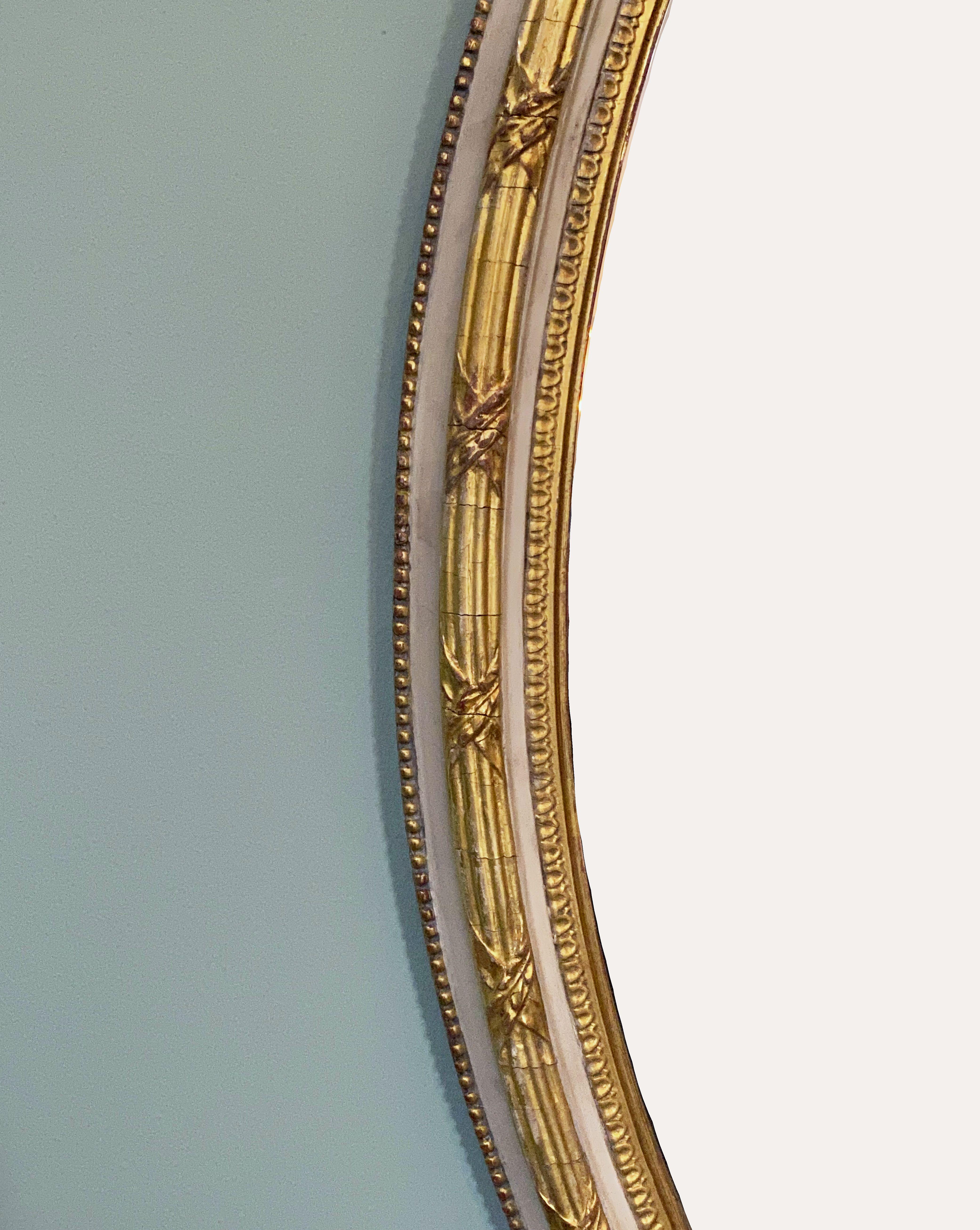 French Gilt and Parcel Cream Oval Wall Mirror with Ribbon Tied Crest and Frieze  5