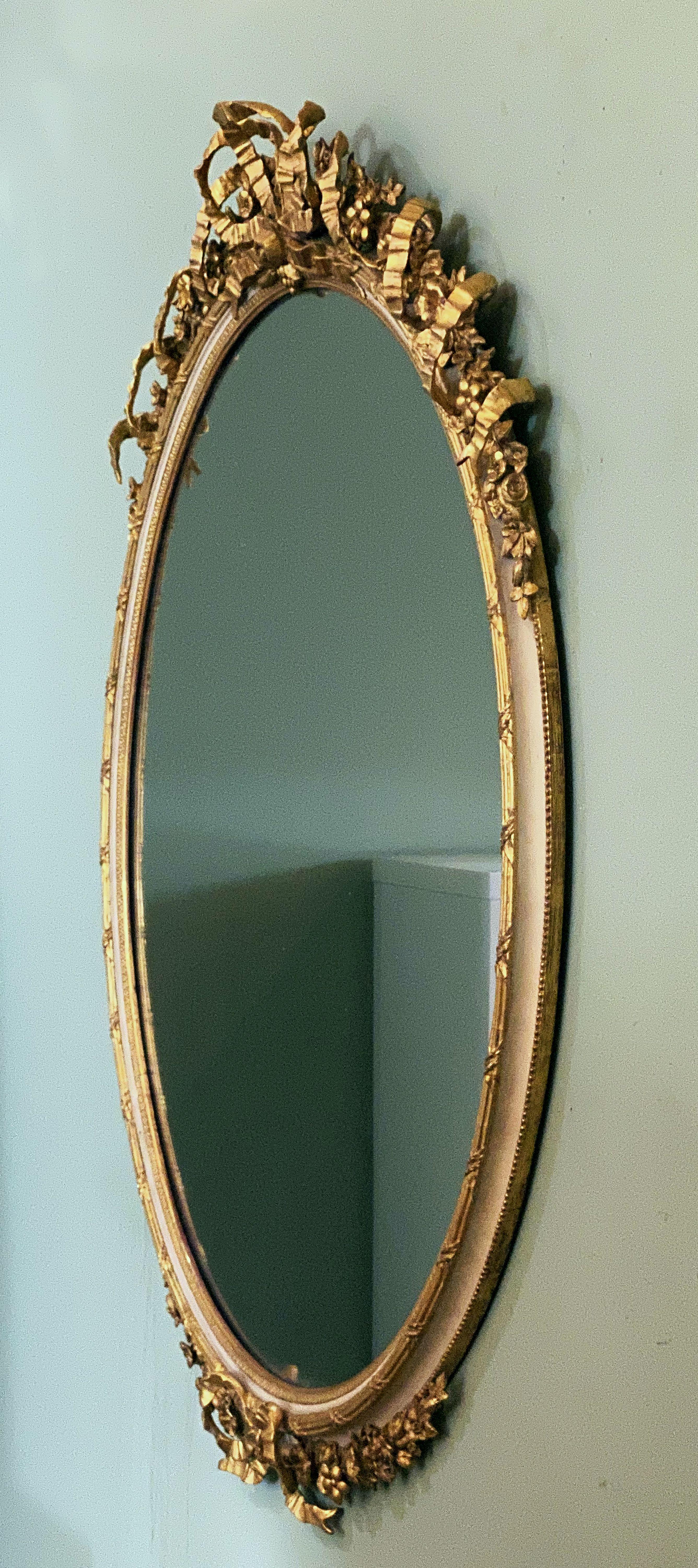 French Gilt and Parcel Cream Oval Wall Mirror with Ribbon Tied Crest and Frieze  In Good Condition In Austin, TX