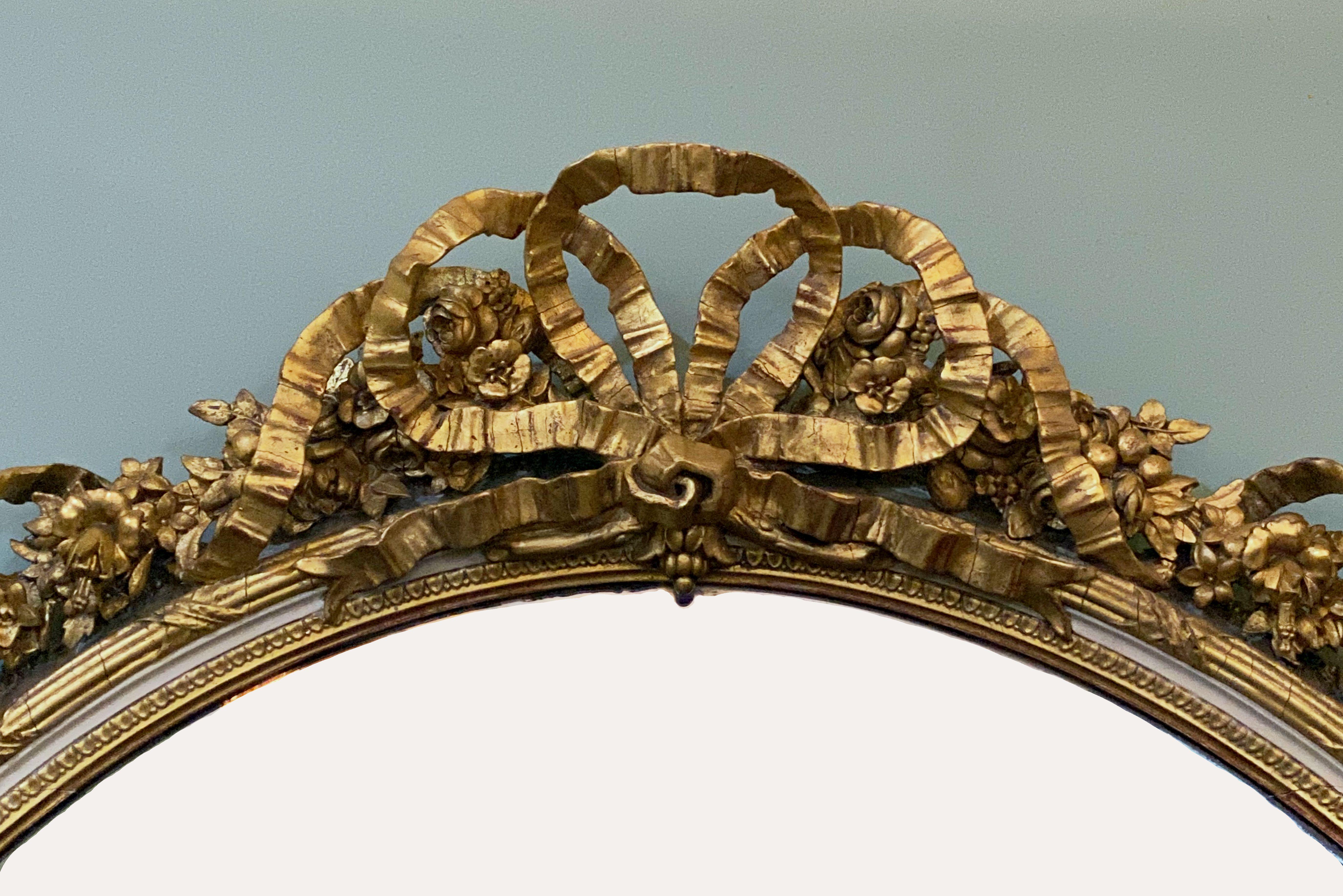 19th Century French Gilt and Parcel Cream Oval Wall Mirror with Ribbon Tied Crest and Frieze 