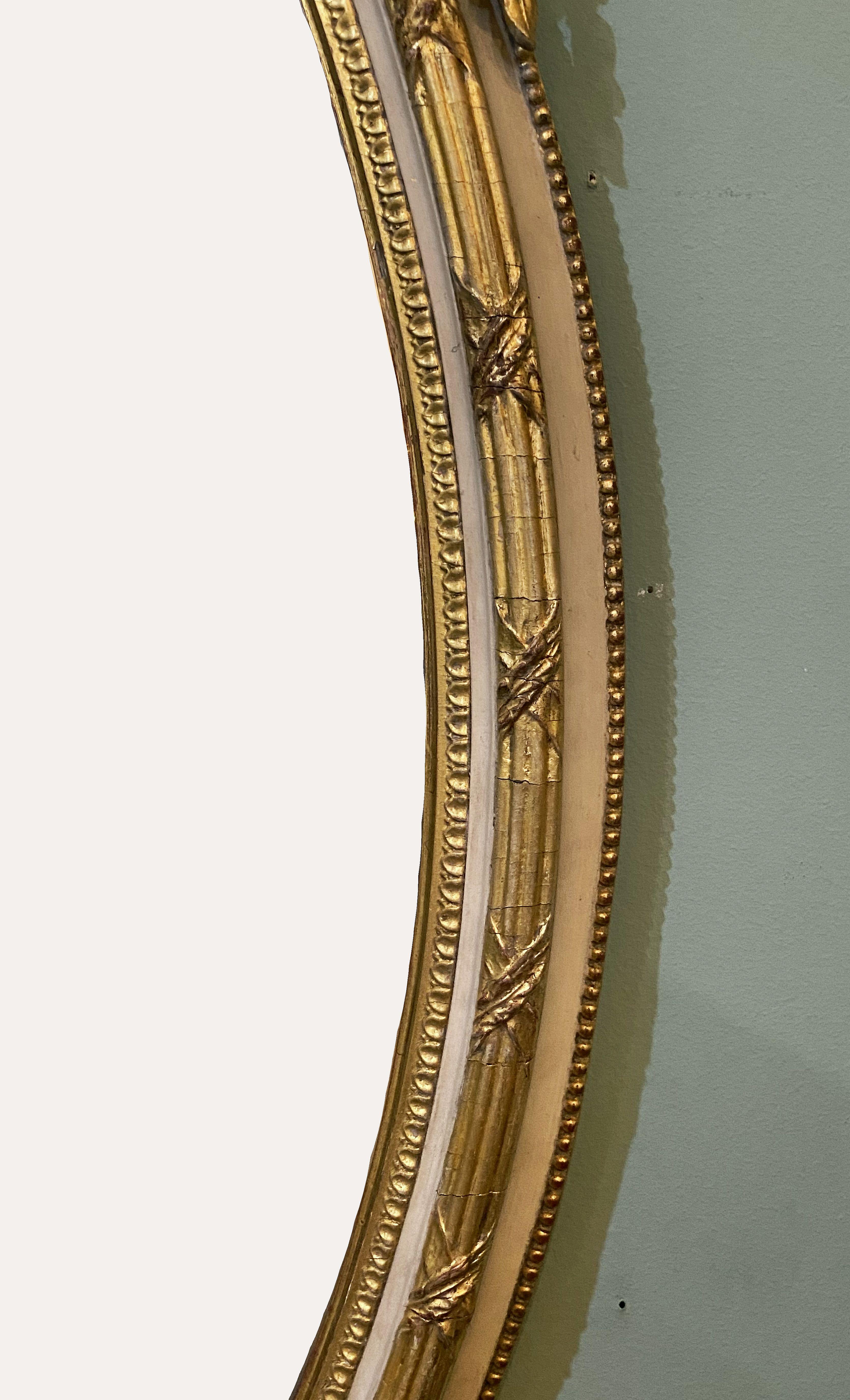 French Gilt and Parcel Cream Oval Wall Mirror with Ribbon Tied Crest and Frieze  1