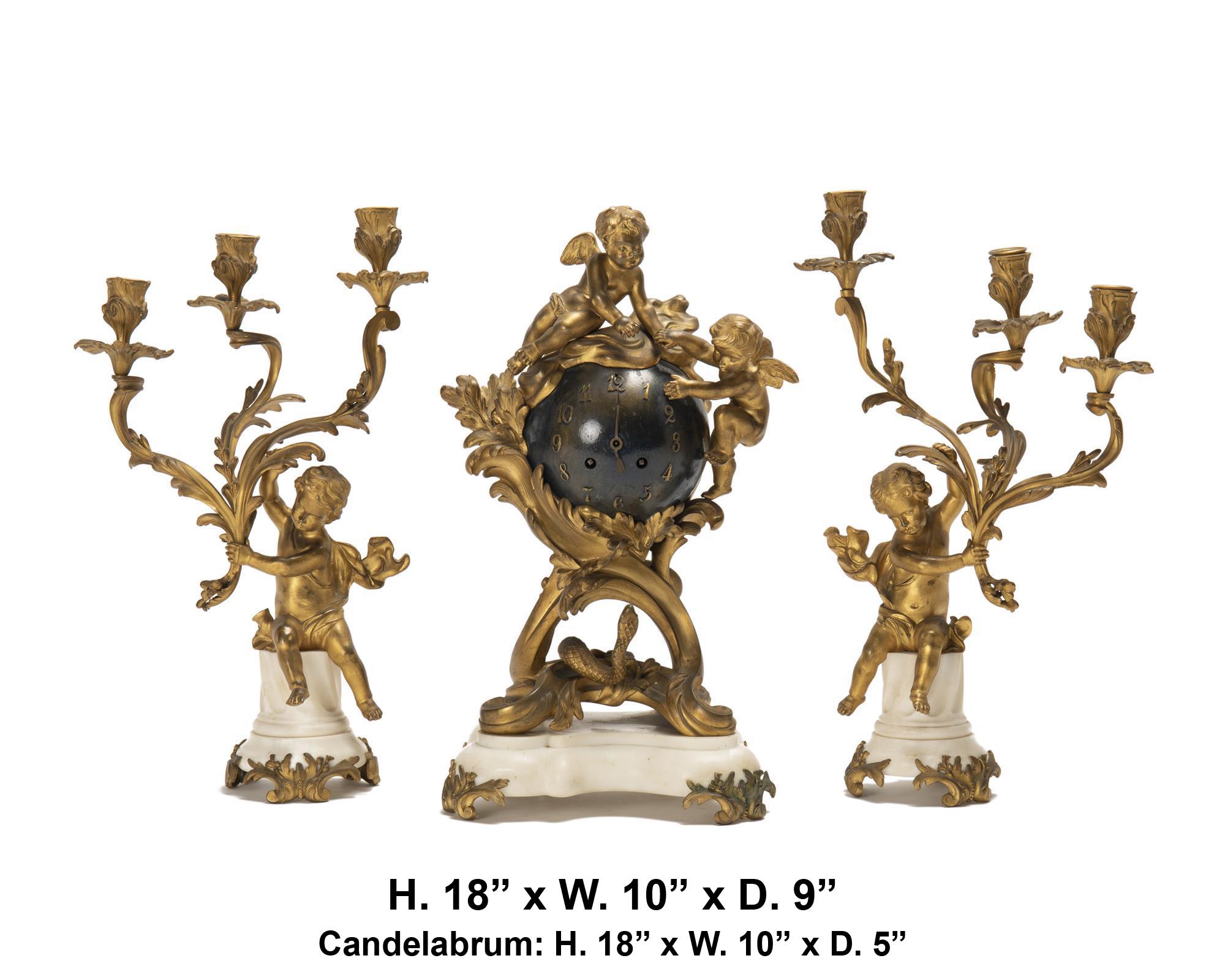 Lovely 19 century French Louis XV-style gilt-bronze and white marble orbital clock 3 piece.  garniture set
Stamped: Medaille d'Argent / S Marti / 1889 
The clock surmounted by two winged putti over a steel globe clock with Arabic numerals raised on
