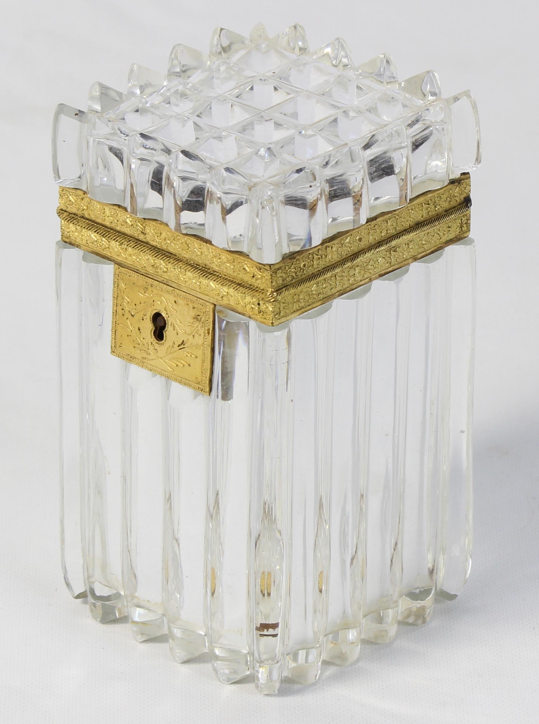 A late 19th century French cut crystal lidded box with gilt bronze accents and original key.