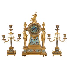 French gilt bronze and enamel three-piece clock set