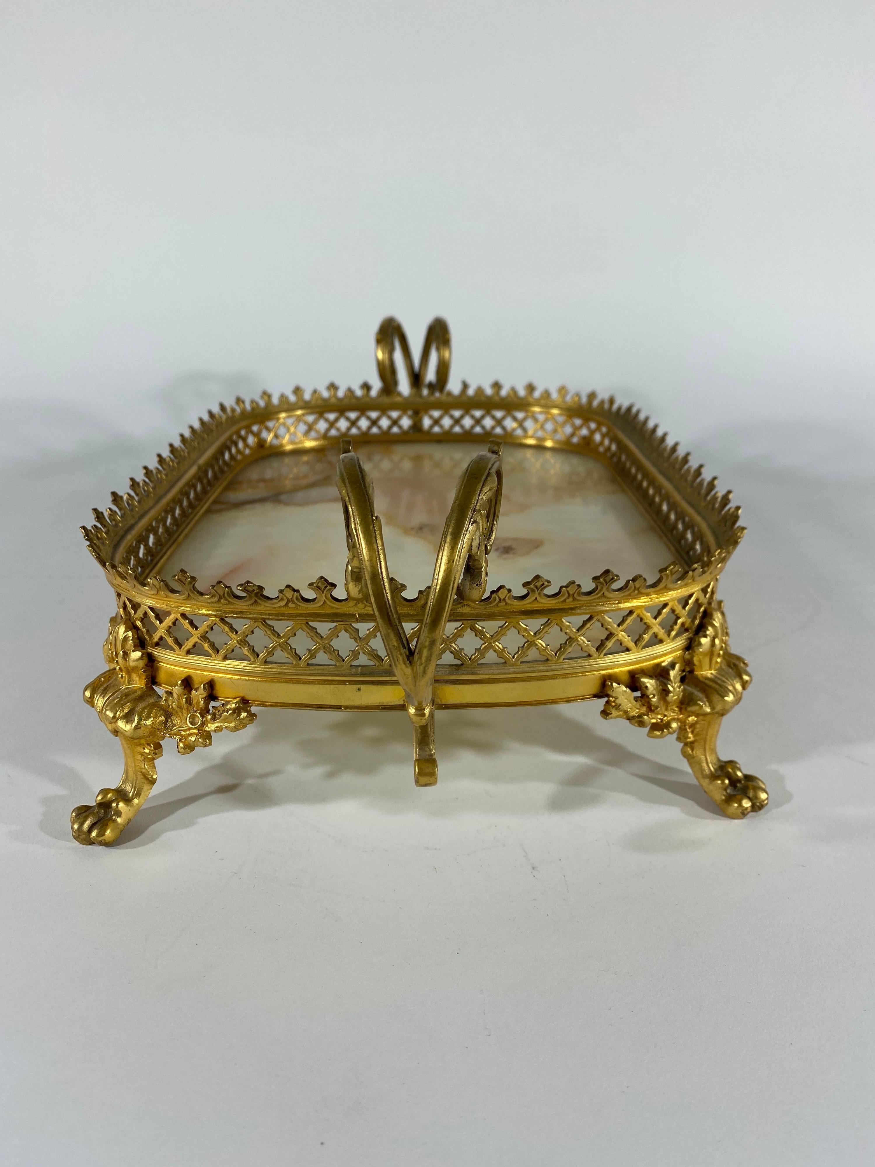 French gilt bronze and onyx dresser tray or plateau. Handled on four paw feet with reticulated gallery and onyx floor.