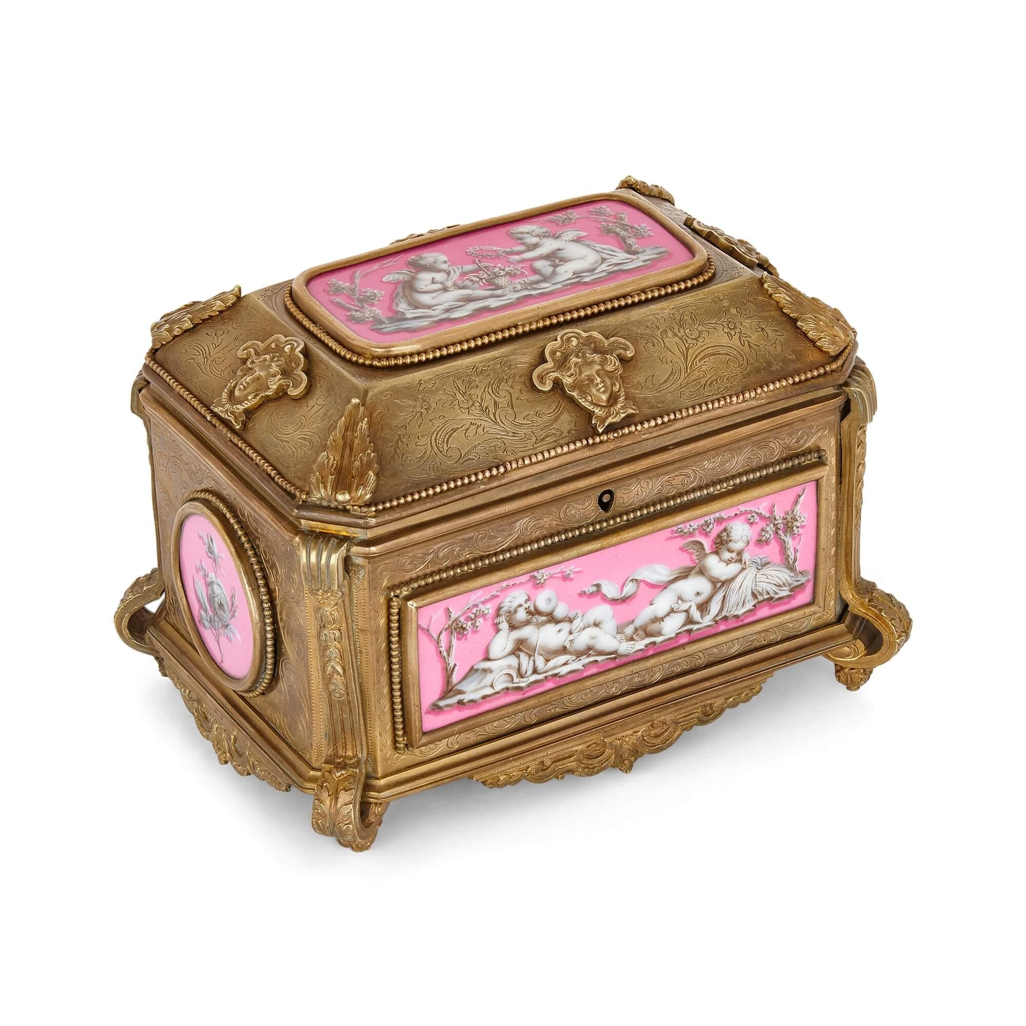 French gilt bronze and pink porcelain jewellery box by Tahan.
French, late 19th Century
Measures: height 13cm, width 18cm, depth 13cm.

This fine jewellery casket by the French maker Tahan is crafted from porcelain and gilt bronze. The casket
