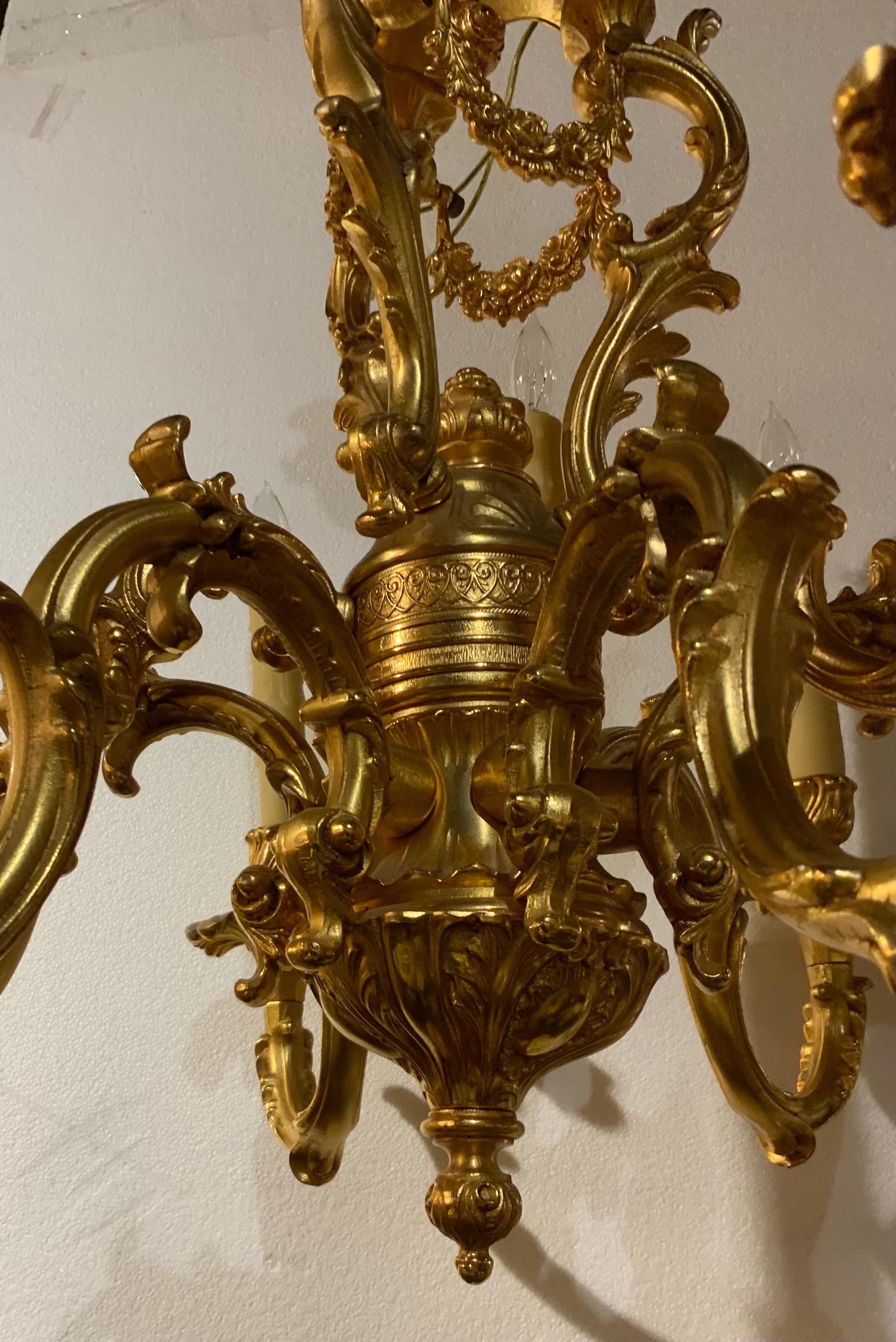 20th Century French Gilt bronze chandelier in the Louis XV taste, nine light with floral swag For Sale