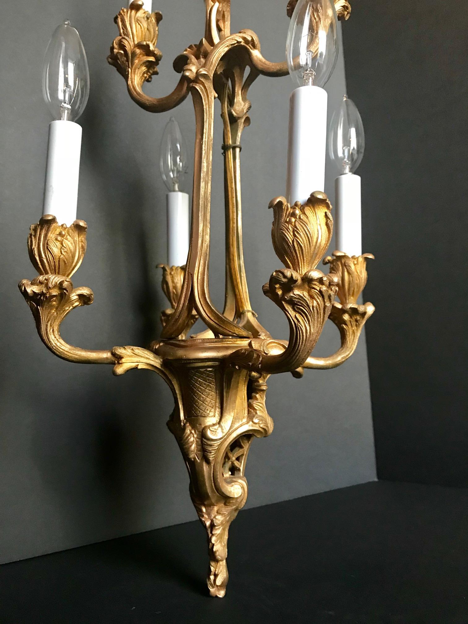 The six arms are in the form of swirling acanthus leaves in the exuberant Louis XV style. This finely chased chandelier was made in France, circa 1870. A high quality bronze casting.

Size: 19 H x 11