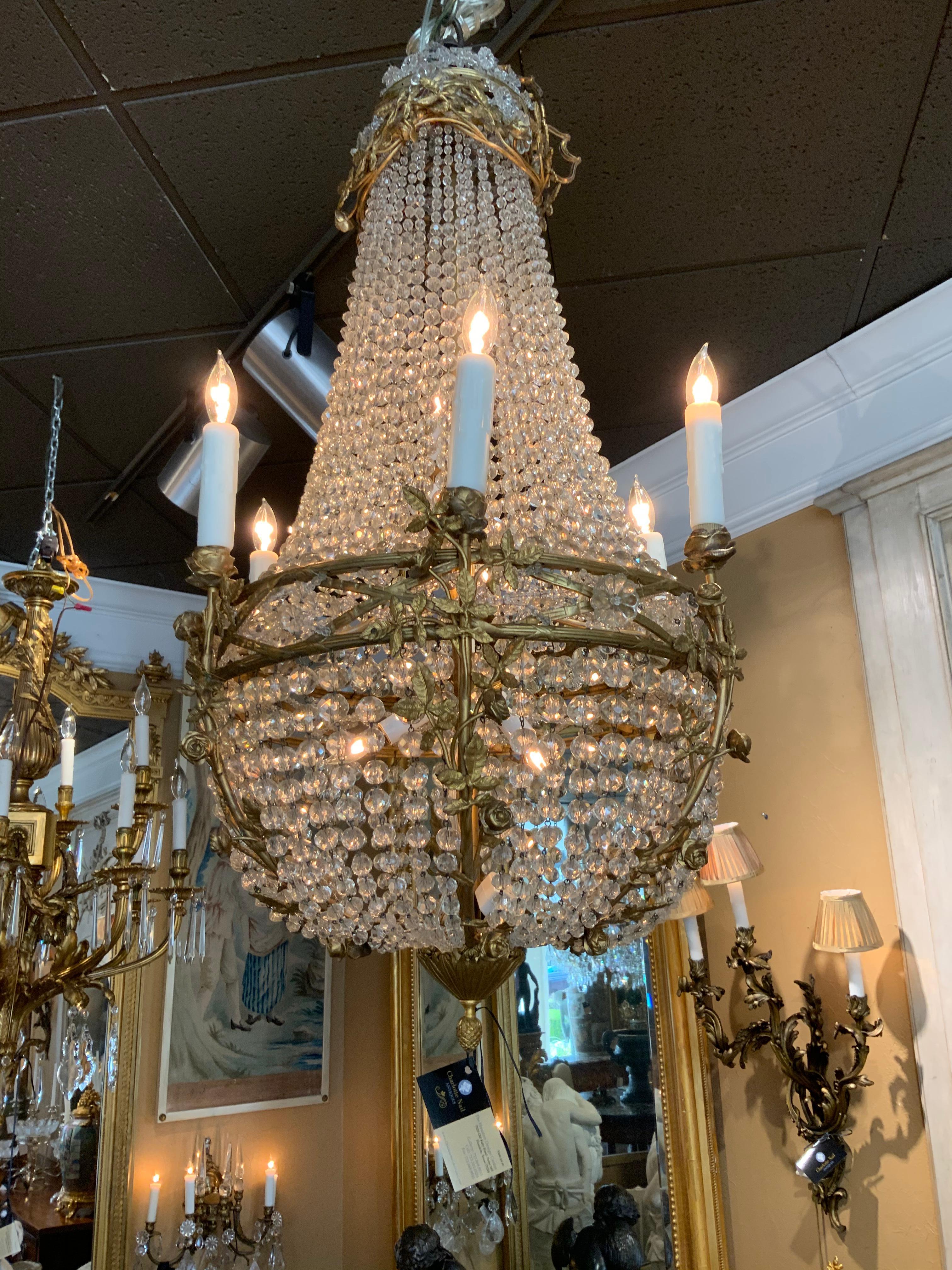 French sac de pearl empire style chandelier with crystal beads and bronze dore floral decorations,
Ending in an acorn finial.