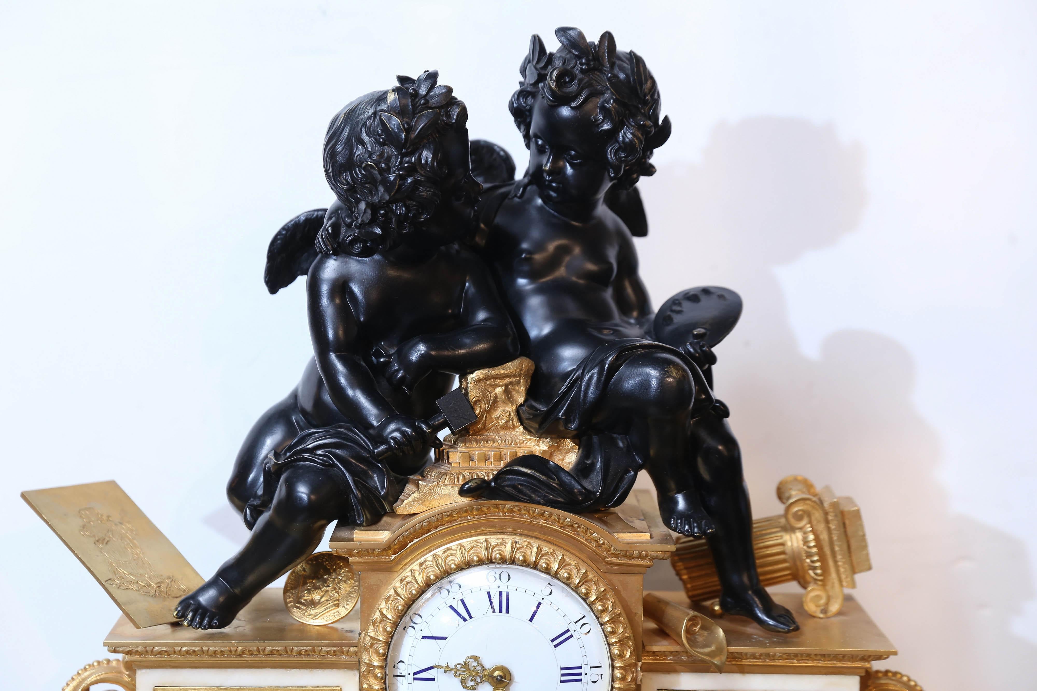 Gilt bronze clock with patinated bronze figures of two angels sitting on the
Crest of the clock. One holding an artist pallet and the other holding a sculptors
Chisel depicting their love of art. A panel in patinated bronze rests above the marble