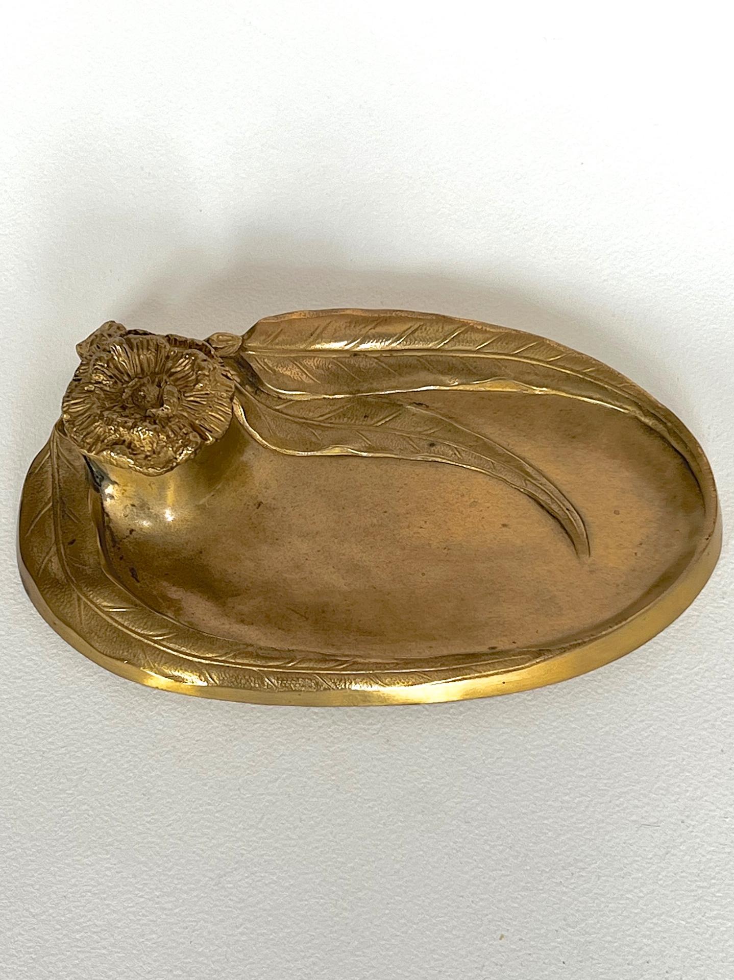 A beautiful gilt bronze combination coin tray and inkwell delicately cast with Eucalyptus leaves, gum blossoms & gum nuts. Of oval form the ink well is raised from a cluster of leaves with the lid cast in the form of a gum blossom. The internal