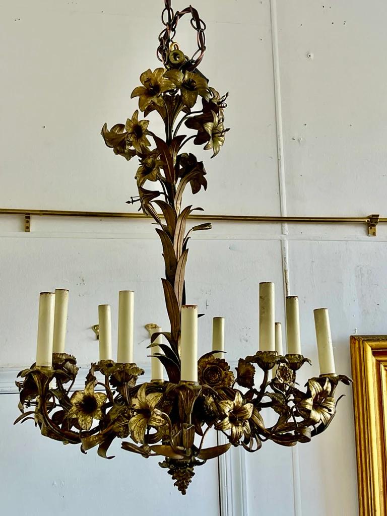 Stunning French ormolu gilt-bronze floral Chandelier, late 19th to early 20th century, gilt bronze twelve-light chandelier, decorated with multiple flowers. Measures: 28” height. x diameter. 22