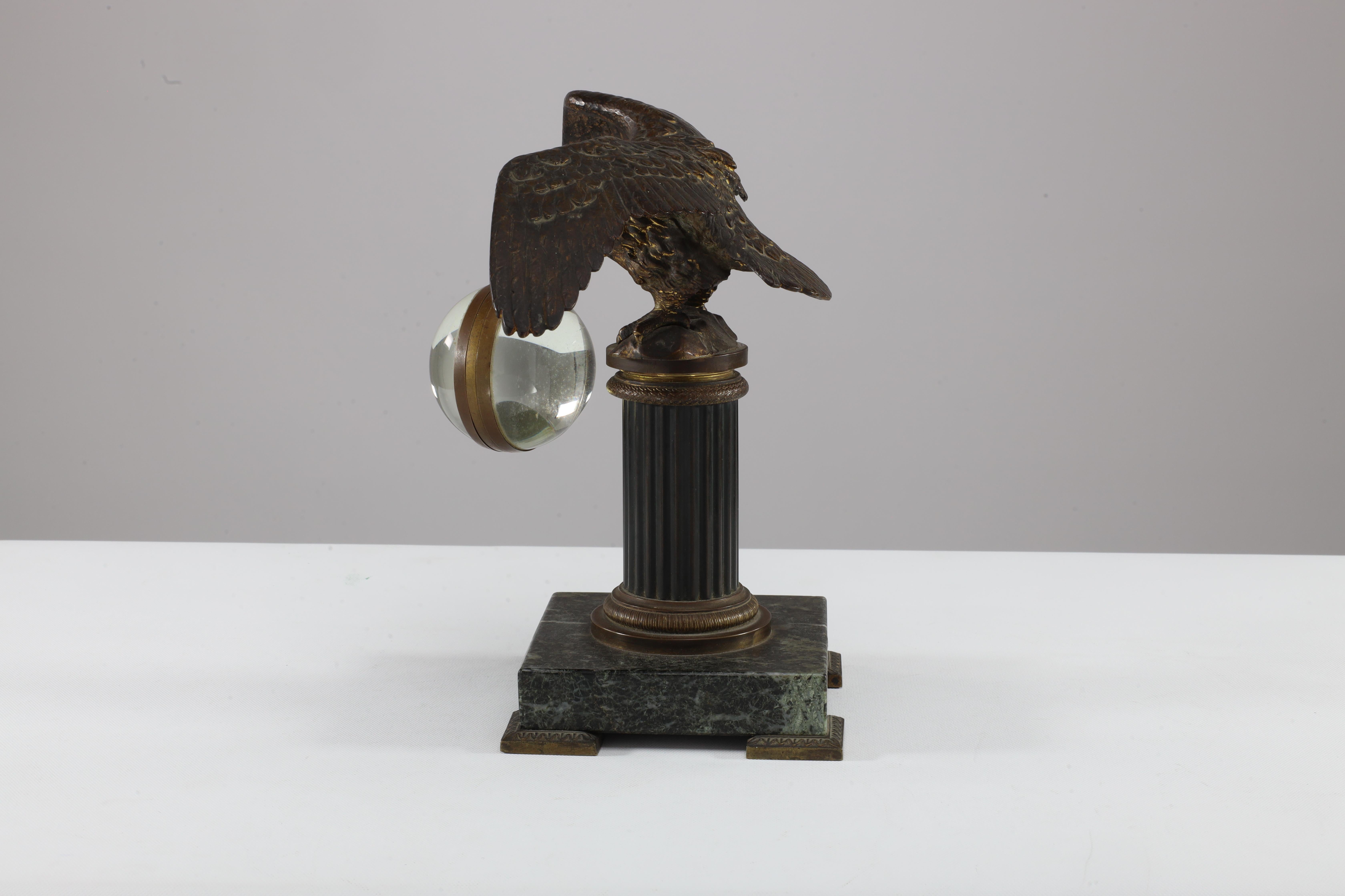 French gilt bronze fob watch holder with an eagle and her wings spread apart about to take off from a corinthium column on a square marble base with bronze feet, indistinctly signed with the french word 