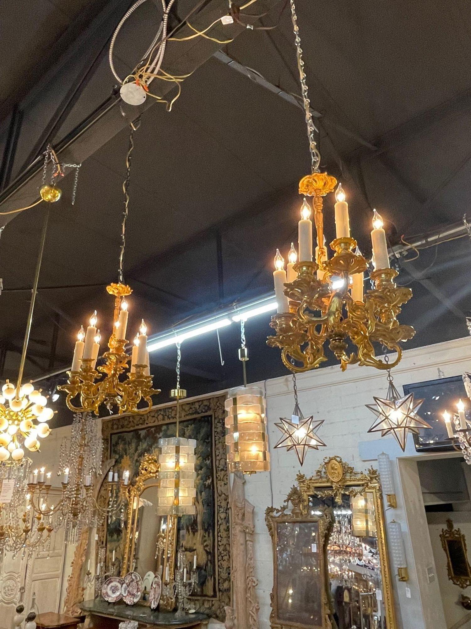 Petite French gilt bronze Louis XVI style chandelier with 8 lights. Circa 1880. A timeless and classic touch for a fine interior. 
 