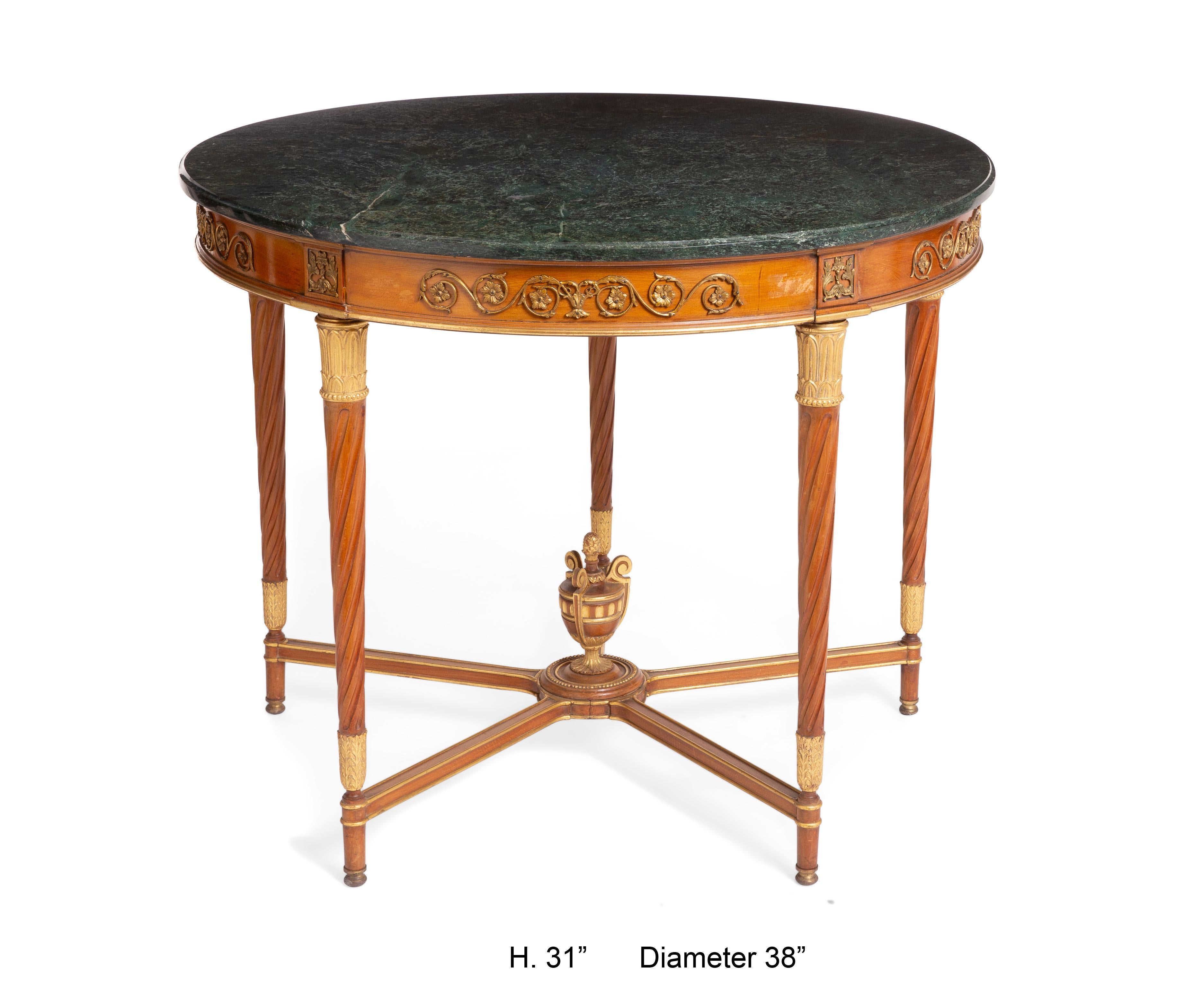 An elegant French Louis XVI style gilt bronze mounted fruitwood five-legged center table with Verde Antico marble top, circa 1900.
Possibly Jensen.

Circular moulded Verde Antico marble top, above a conforming frieze with gilt bronze appliques in