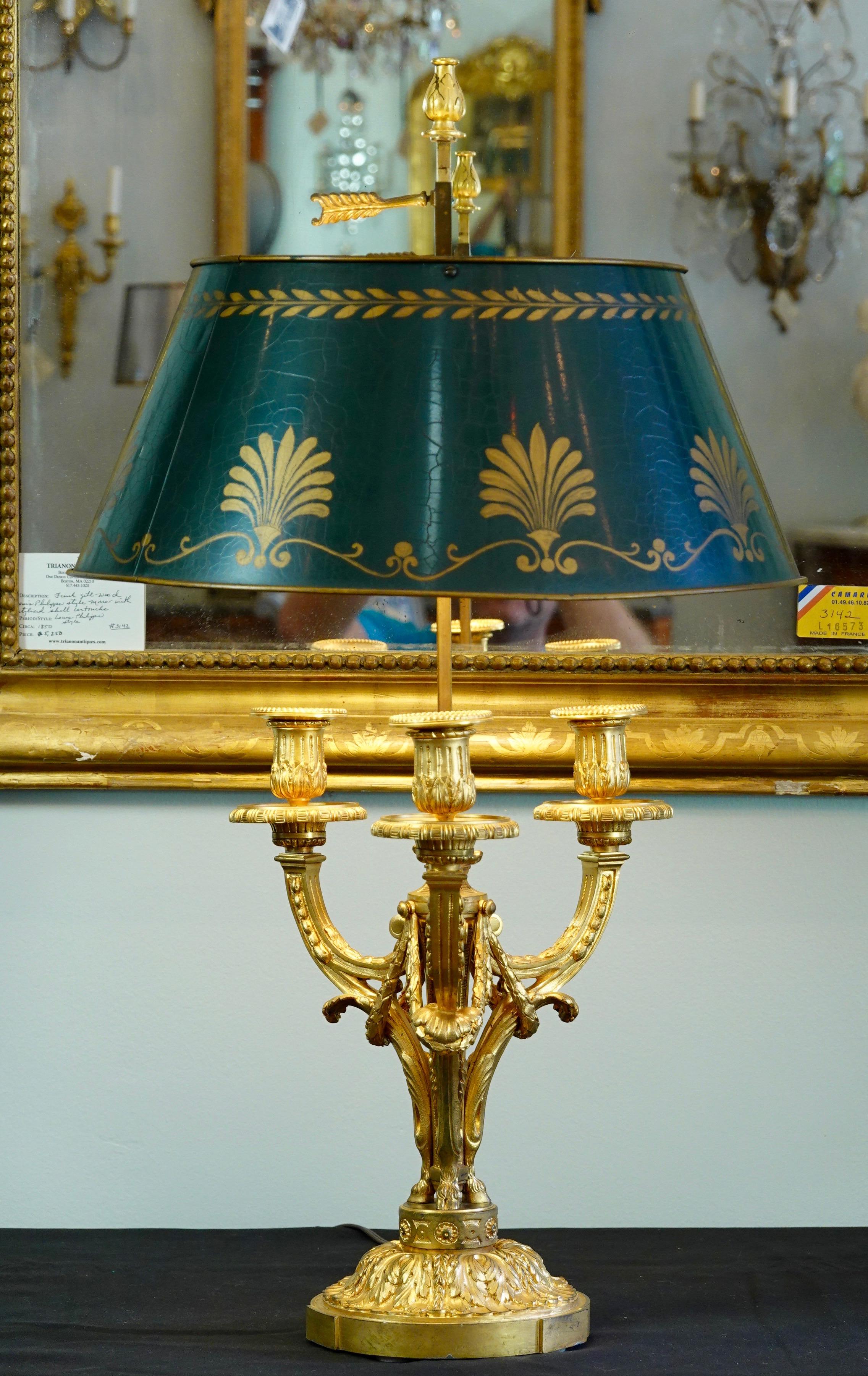 Very nice quality, French, Louis XVI style gilt bronze Bouillotte lamp with green painted tole shade, (19th century). The lamp features nicely chiseled acanthus leaves, garlands, central flame, hoofed feet and other neoclassical details. The painted