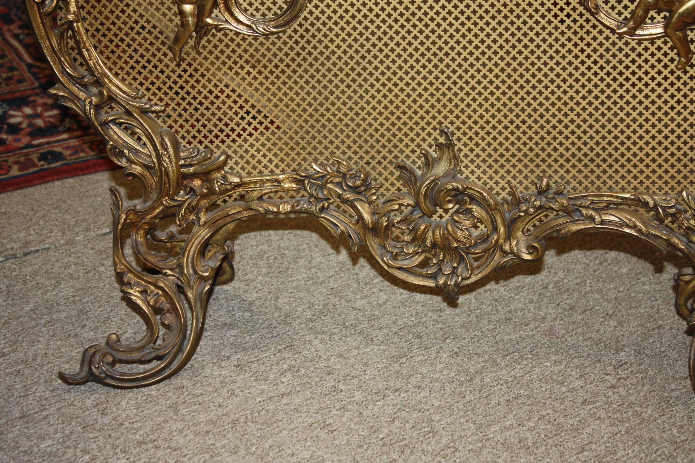 Wonderful French gilt bronze scroll fire place screen with decorative motifs and elaborate frame, late 19th century.