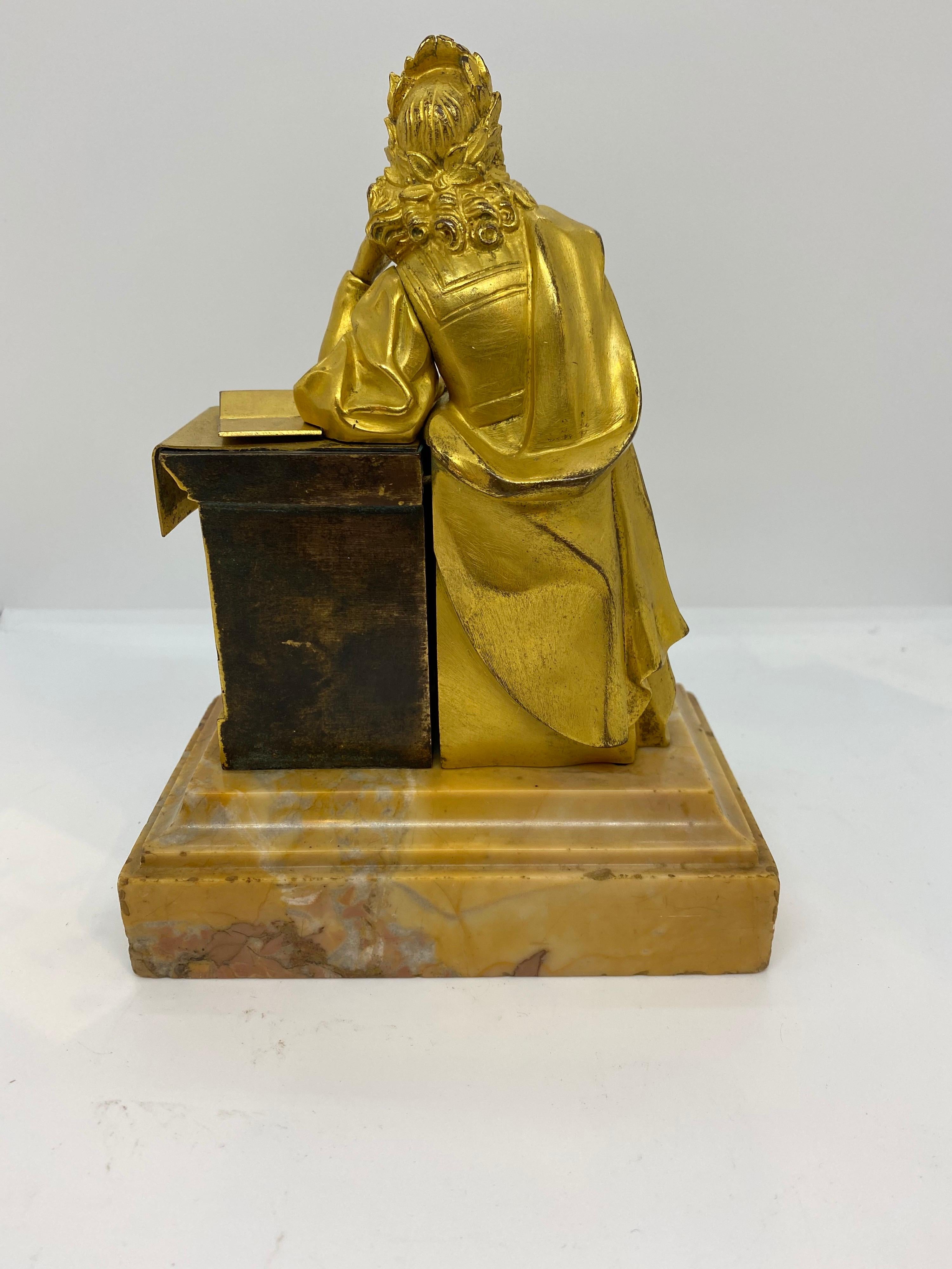 French gilt bronze seated figure at a plinth on sienna marble base.