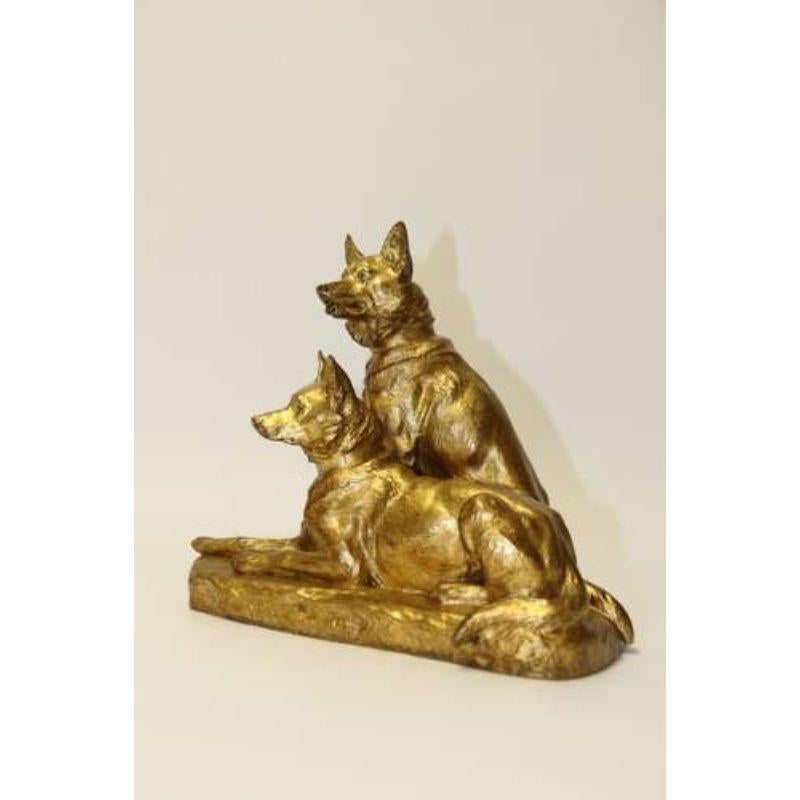A Fine French Gilt Bronze Study of Two German Shepherd Dogs by Louis Riche

This impressive bronze is finely detailed. It portrays two working german shepherd dogs. The nearest is laid down and his companion is seated behind him. They both have an