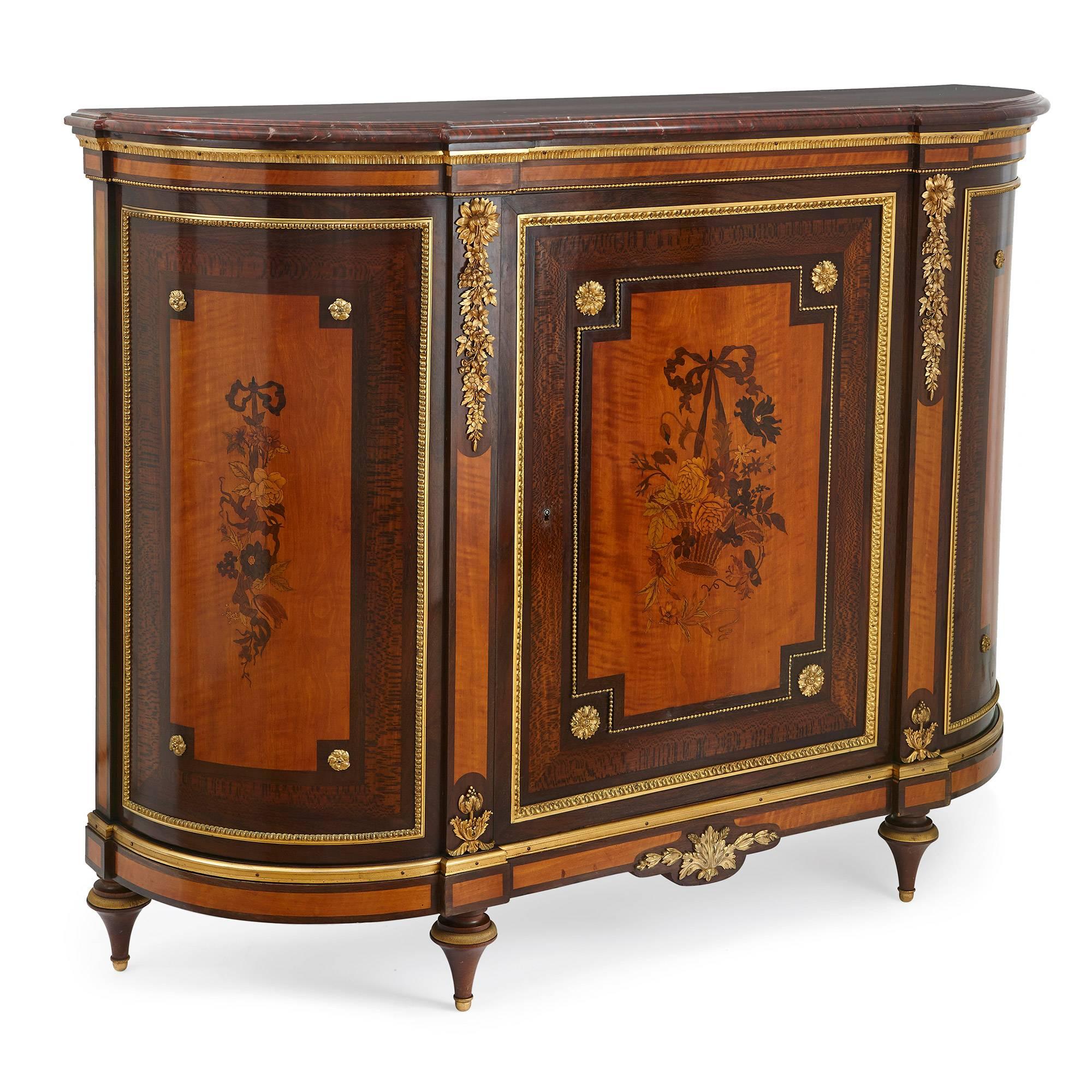 This stunning and elegant cabinet was designed and created by the famed 19th century Parisian ebeniste, Jean-Louis-Benjamin Gros. Featuring detailed inlays, contrasting woods and sumptuous gilt bronze mounts, the cabinet embodies fine craftsmanship