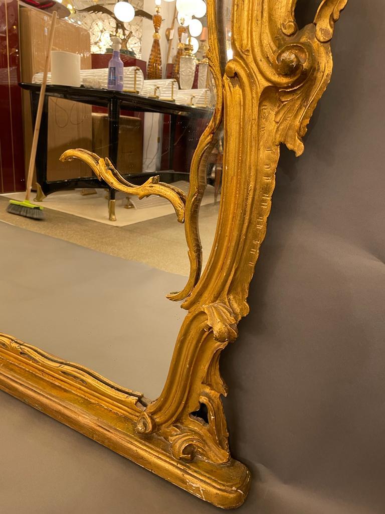 French gilt carved wood wall / mantel mirror with centred floral cartouche, original glass. In overall good conditions there is some gilt missing, please see images.