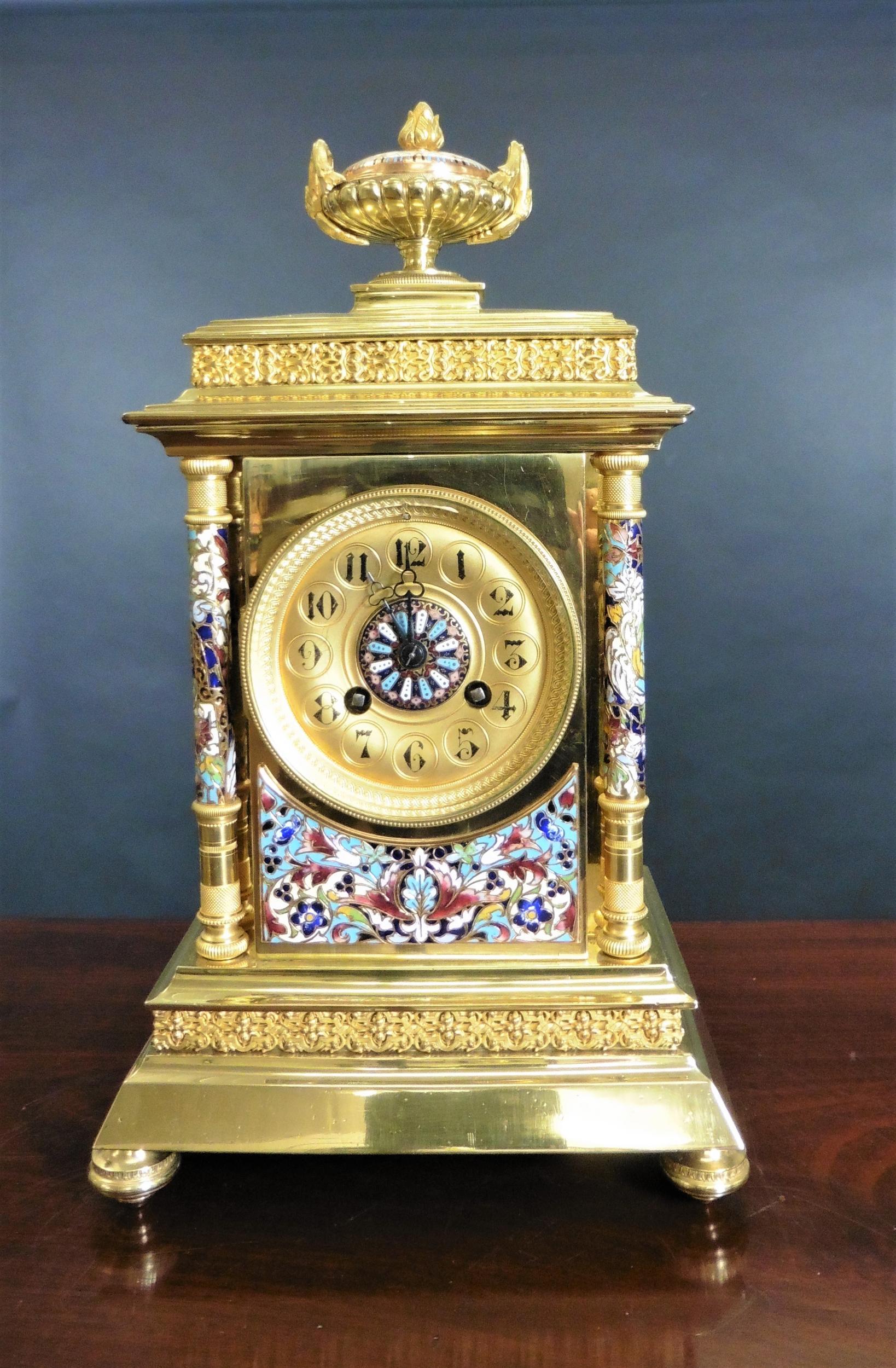 French gilt champleve clock garniture

Rectangular case standing on a stepped moulded base with turned feet, applied frieze decoration below a beautifully decorated champleve enamel panel with finely turned, chased blue champleve pillars with