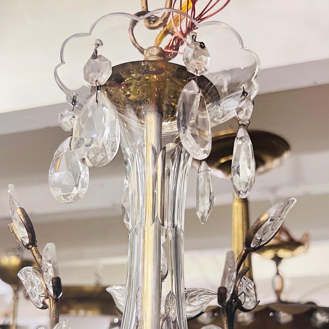 A circa 1940s French gilt metal chandelier with molded glass leaves with 6 candelabra lights.

Measurements:
Height: 22