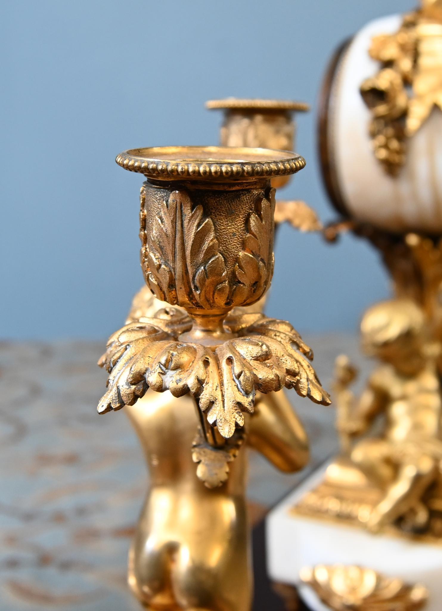 Absolutely stunning antique French clock set and garniture in marble and gilt
In the Louis XV revival style and circa 1890
This is a stunning French ormolu and white marble clock garniture set, comprising a central mantel clock flanked by a pair of