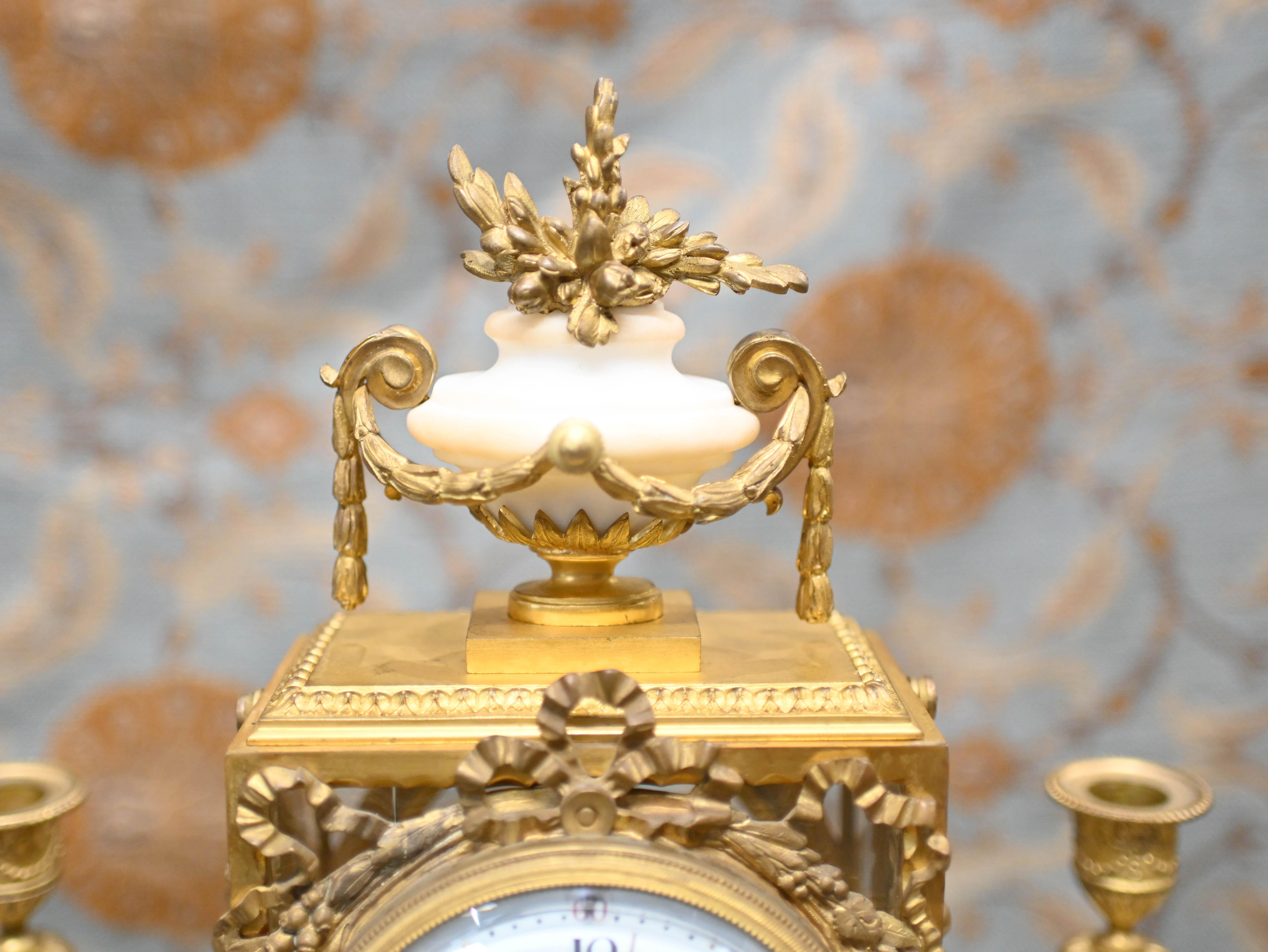 Wonderful French antique clock set with garniture
Classic mantle clock crafted from gilt and marble
The clock has a chiming mechanism which chimes on the hour 
Hopefully the photos illustrate the details to the gilt very ornate and well cast
Clock
