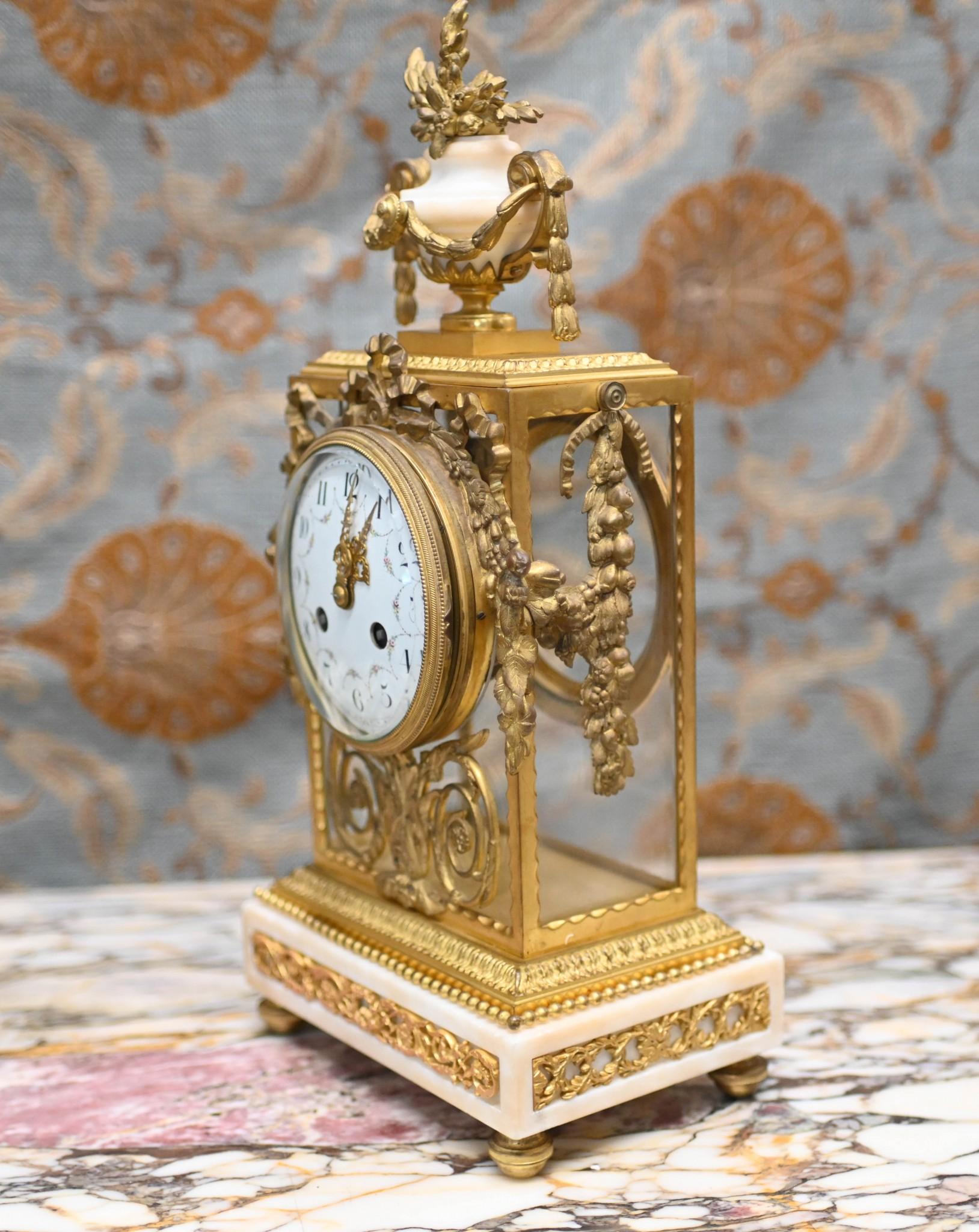 Wonderful French antique clock set with garniture
Classic mantle clock crafted from gilt and marble
The clock has a chiming mechanism which chimes on the hour 
Hopefully the photos illustrate the details to the gilt very ornate and well cast
Clock