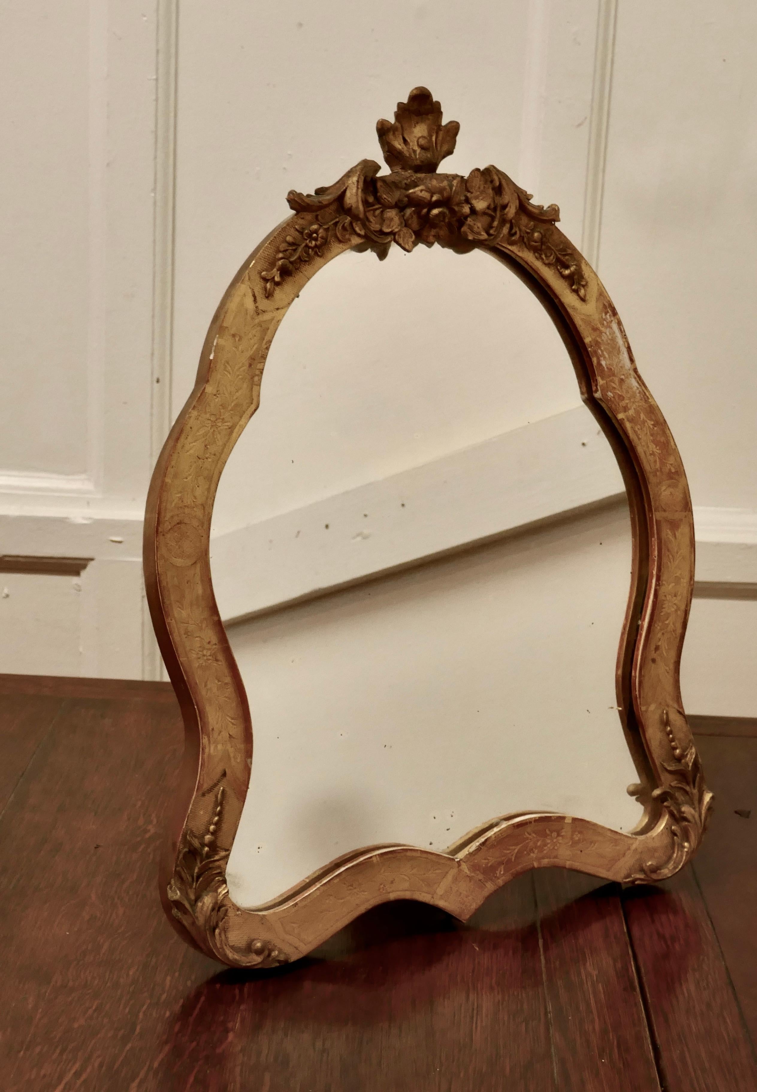 French Giltdressing table and wall mirror

A very pretty piece in Gilt with a shield shape, the really unusual thing about this lovely mirror is that it comes with the ability to be wall hung or slide out the easel stand to use as a dressing