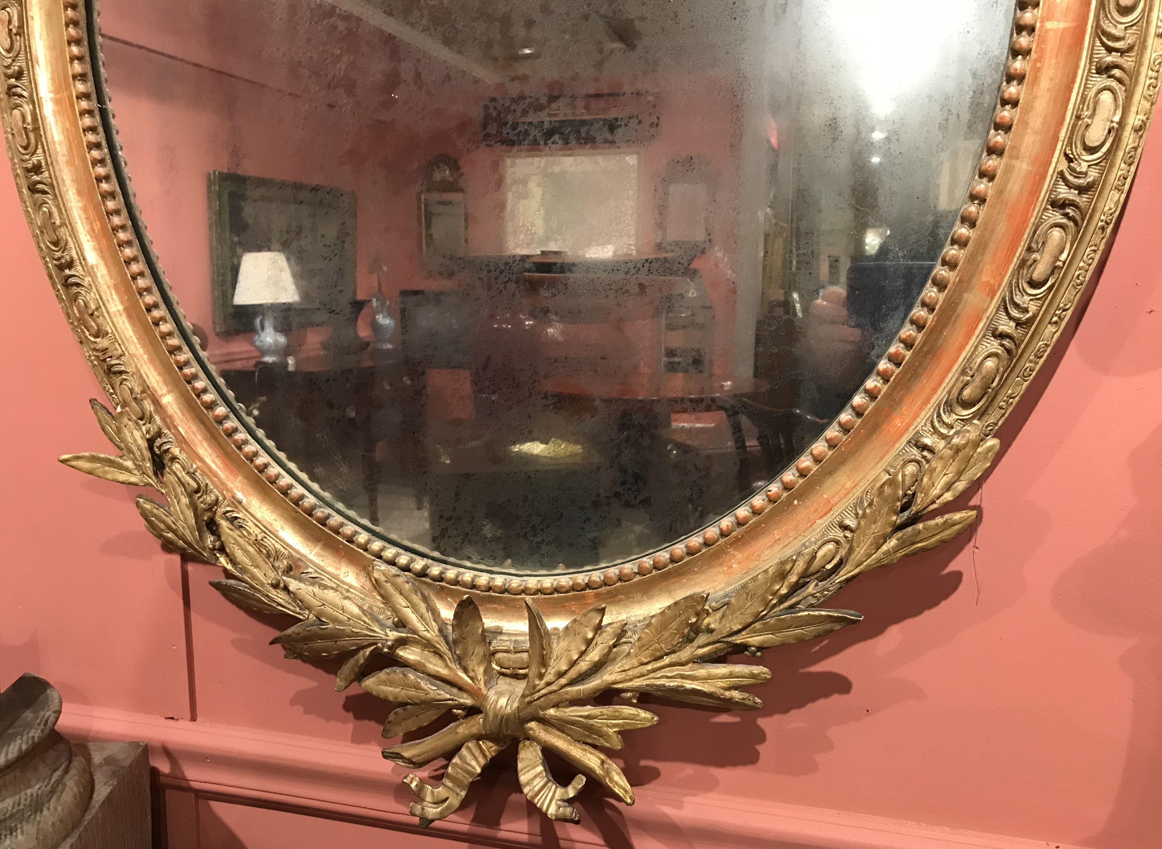 French Provincial French Gilt Foliate Decorated Oval Wall Mirror, Early 19th Century